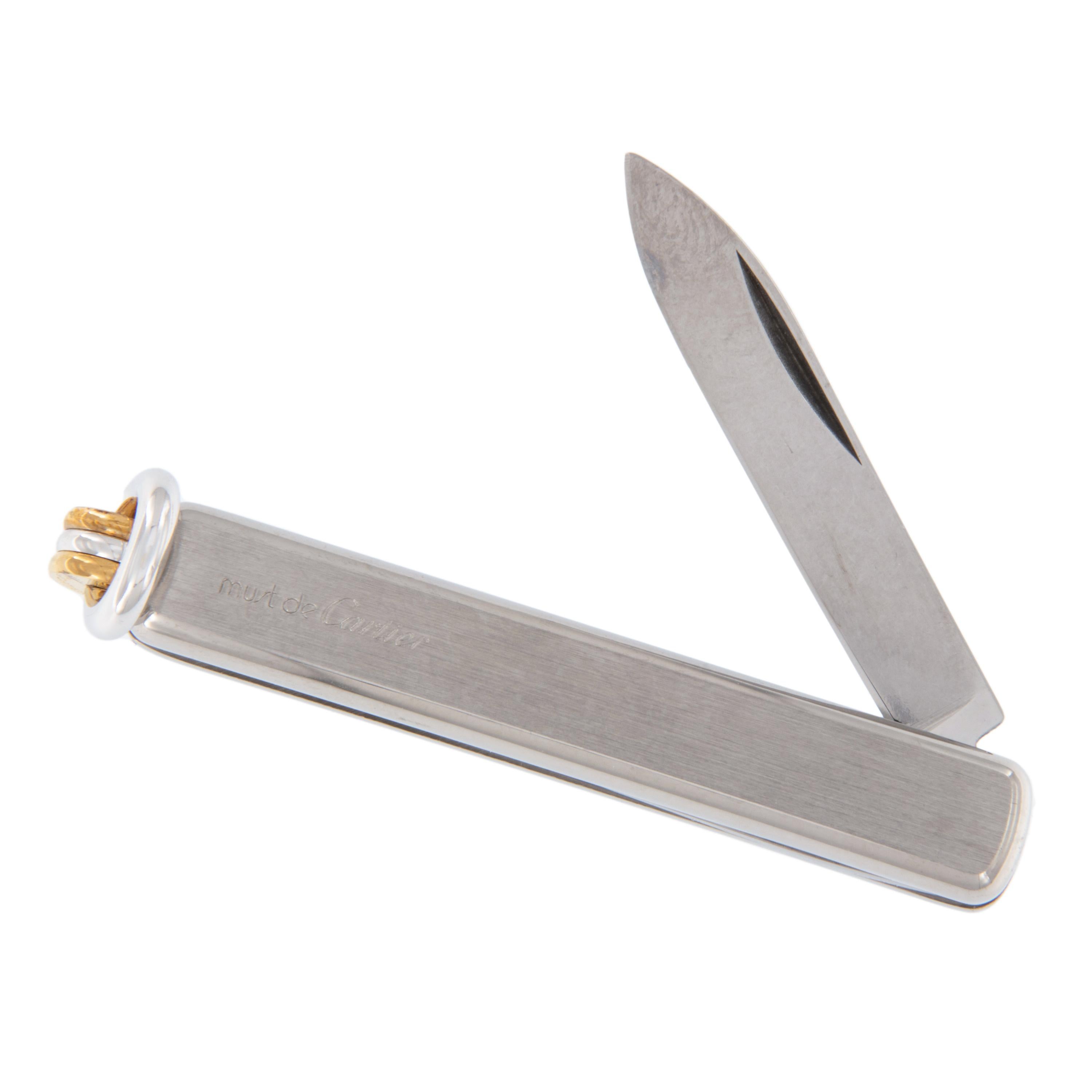 Keep your pocket equipped in style with this brand new, never used 1989 must de Cartier pocket knife with original box! Fully functional with engraving & serial number. Stainless steel and 18k gold trim. Complementary signature wrapping.
