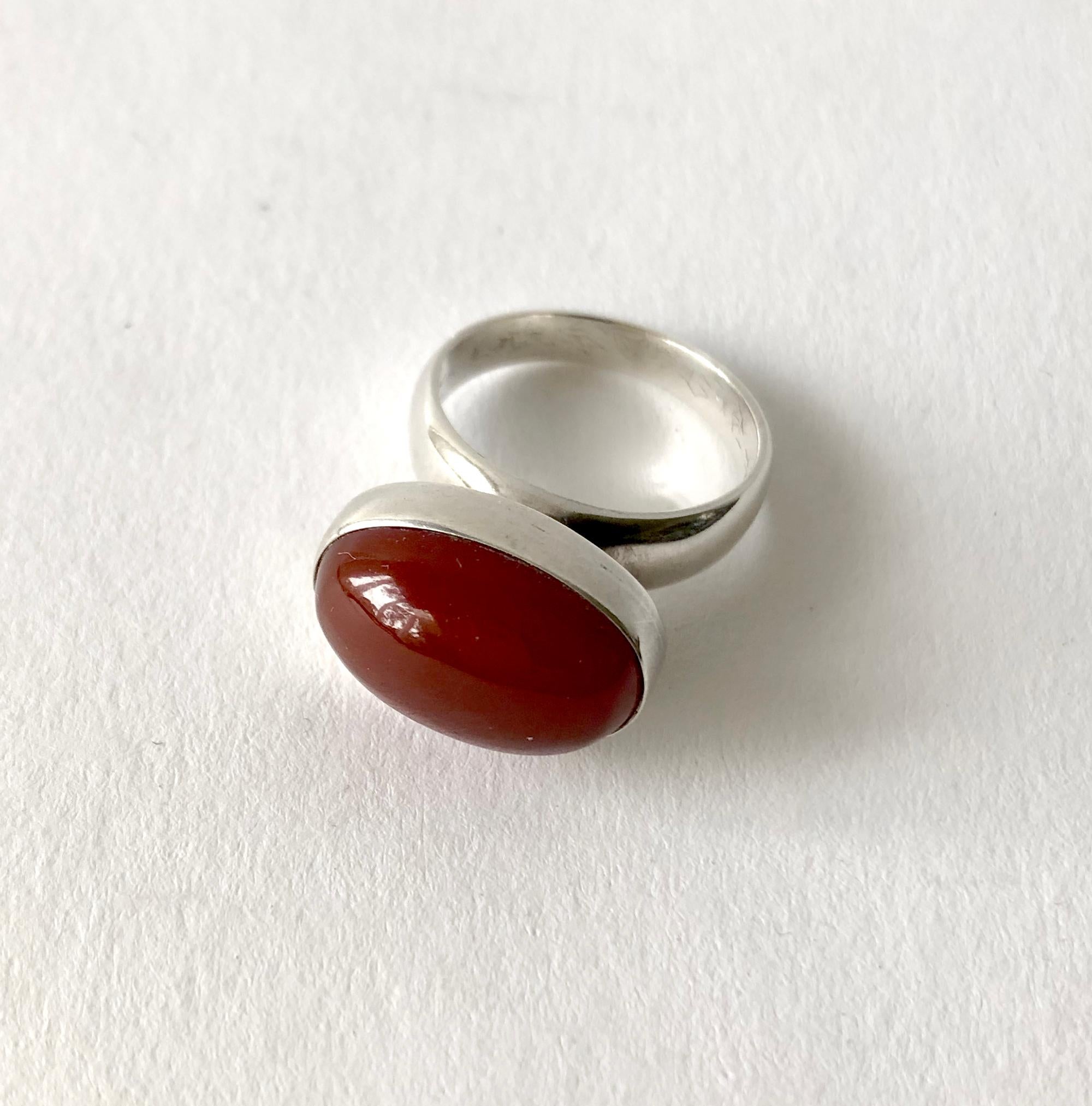 Rare sterling silver ring with carnelian cabochon created by Nanna Ditzel for Georg Jensen.  Ring is a finger size 6.5 to 6.75 and is signed Georg Jensen, Denmark, 123 B.  In very good vintage condition.  