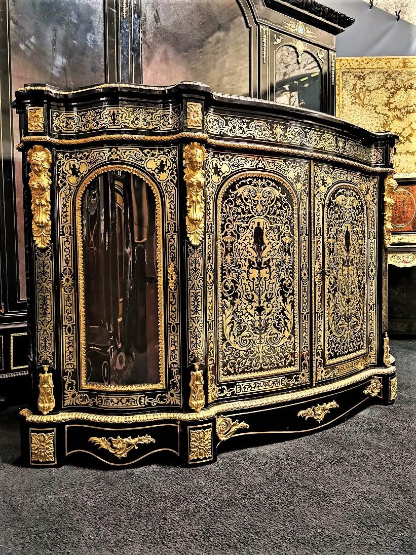 Stunning , very rare and large sideboard credenza with 4 doors in brass marquetry and brown tortoiseshell in a beautiful honey color. Two full main solid doors in the center, and two curved doors on the sides.
Very important ornamentation of gilt