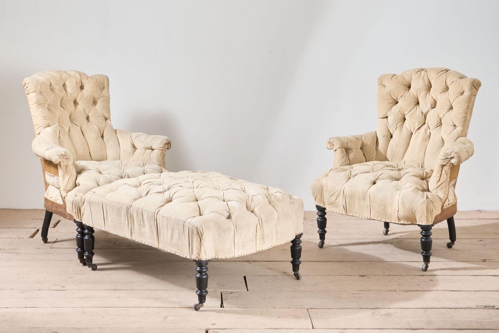 This is a very high quality and rare pair of chairs with matching stool. What sets this apart is the stool can attach to one of the chairs with metal hooks. The fact everything is still all complete and the set still remains together is why it is a