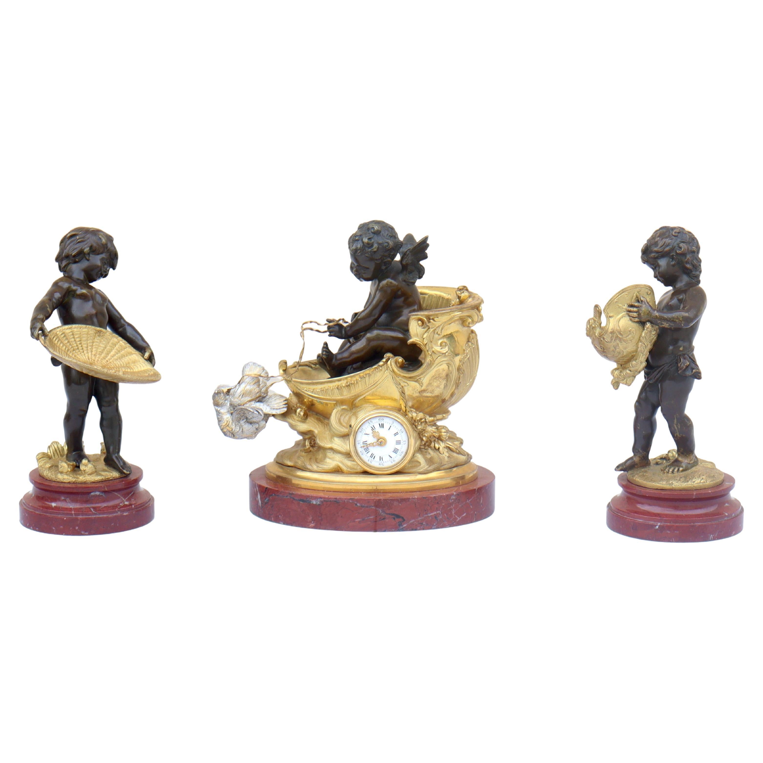 Rare and amazing quality Napoléon III three pieces clock set by Auguste Moreau (1834-1917)
Designed for the clock as the wheel of a chariot set on clouds, pulled by a couple of silvered patina bronze doves and guided by a cupid, and a pair of