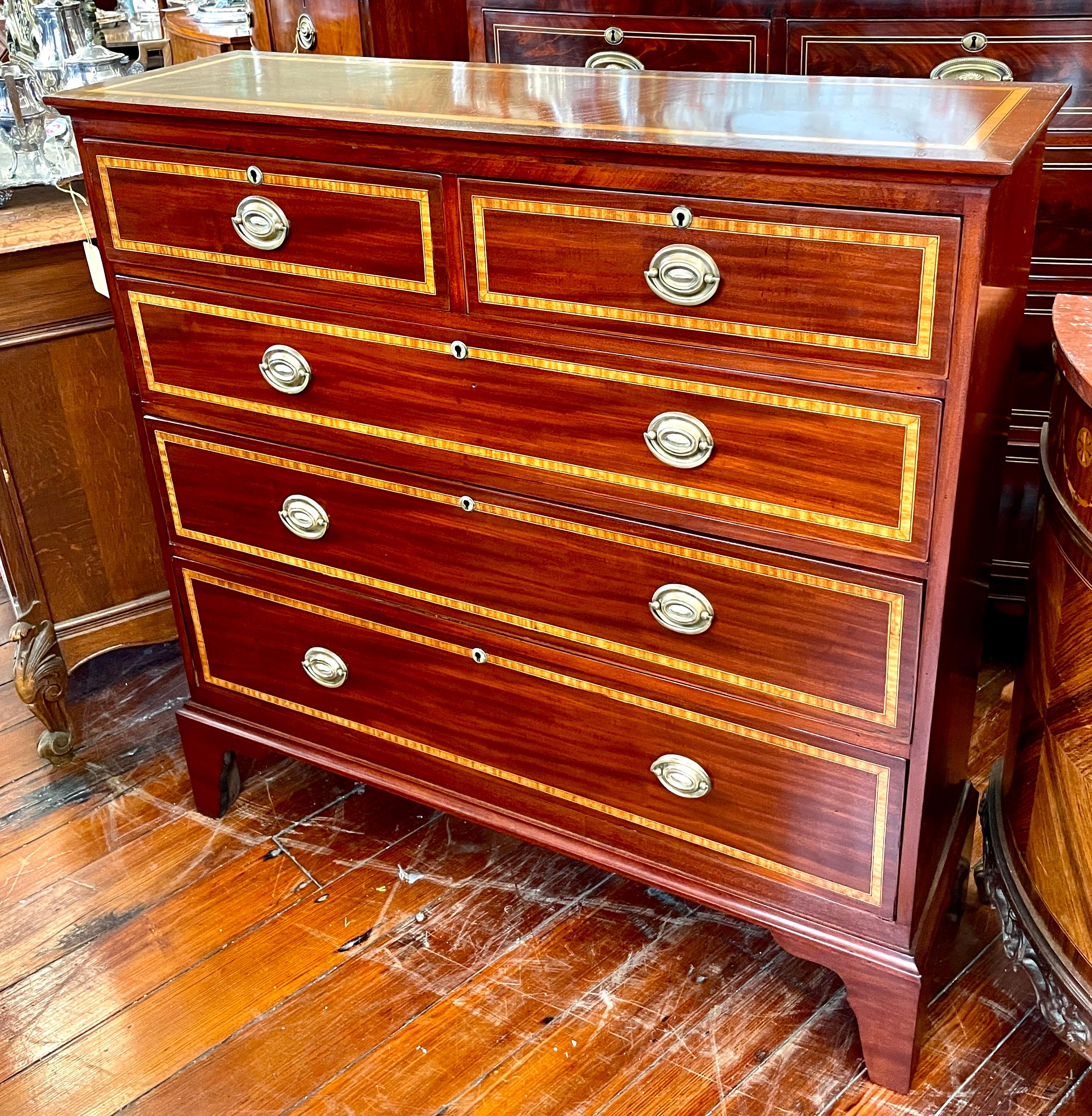 This gorgeous Antique English inlaid flame or figured mahogany two over three Chest of Drawers is unusually narrow with no indication that it has ever been cut down in depth.  This makes it a very useful chest in a hall or bedroom or living room