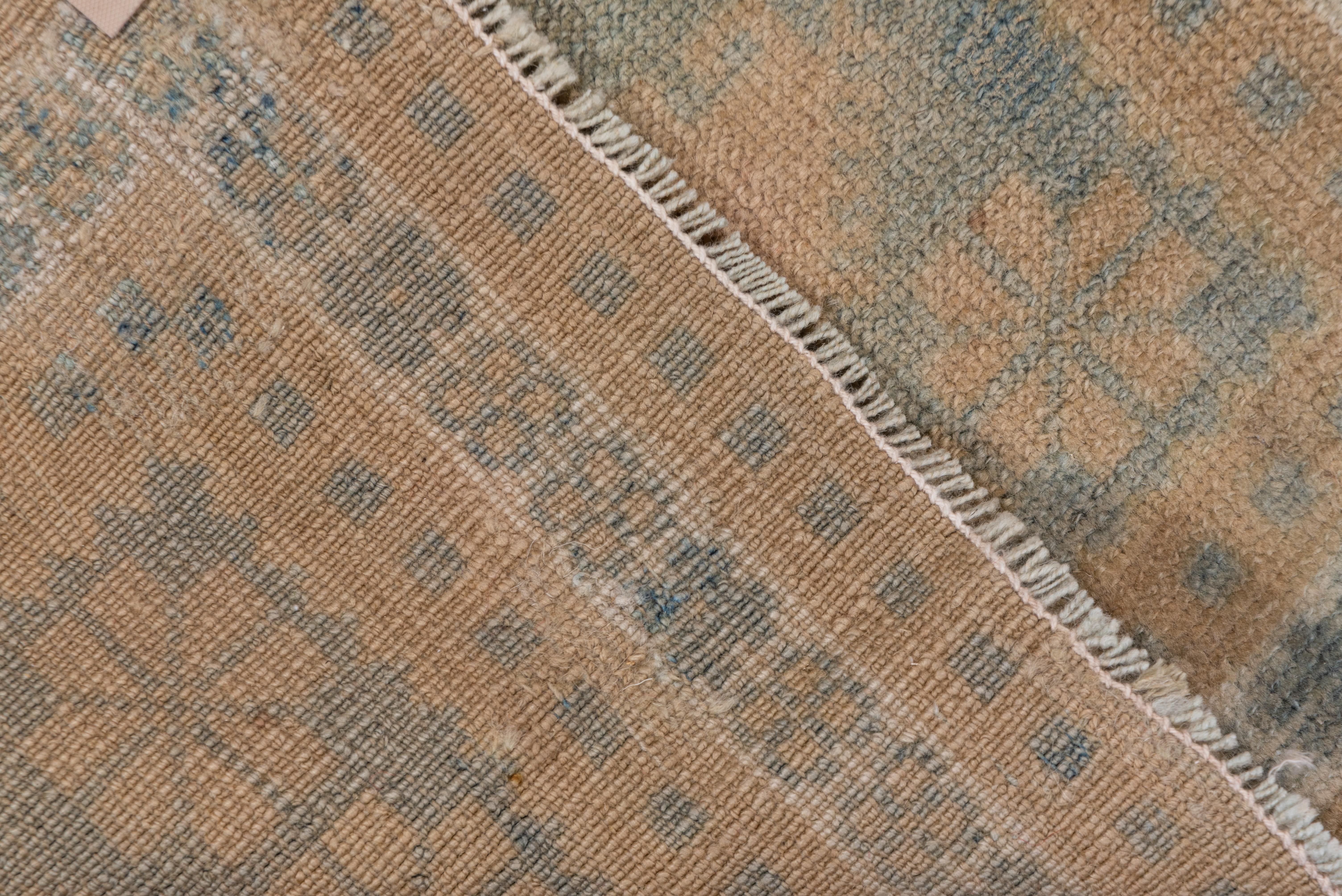This ultra-petite Oushak runner fits anywhere and the light blue-grey field with three columns of palmettes is suitably discreet. Beige border with floating rosettes. Very unique!.