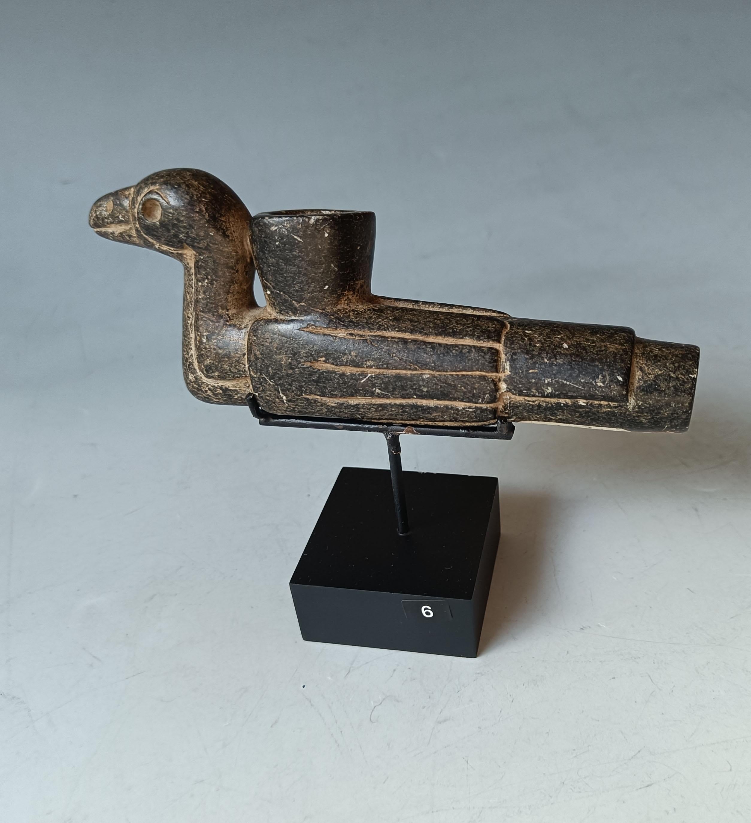 A rare ancient native American Effigy pipe from the Mississippian Circa 12-16 century AD   
A bird effigy pipe with upright neck and delineated line feather with feet detail to the underside, carved in hard green stone. The pipe has a very stylised