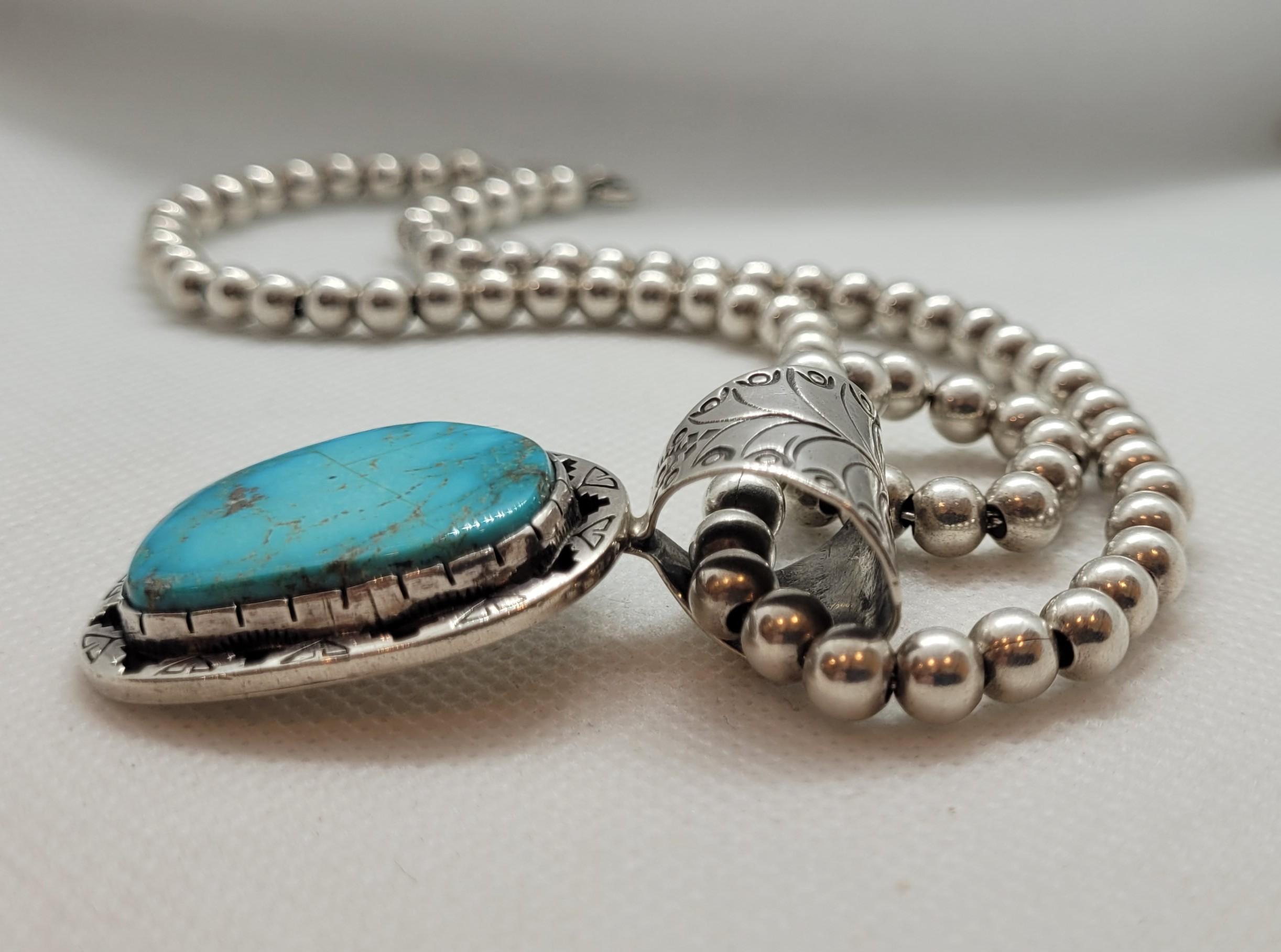 Rare Navajo American Indian Turquoise Sterling Silver Pendant with Necklace Fine - This is a rare sterling silver Native American Navajo pendant featuring a stunning freeform turquoise stone set in a detailed bezel. The bezel showcases traditional