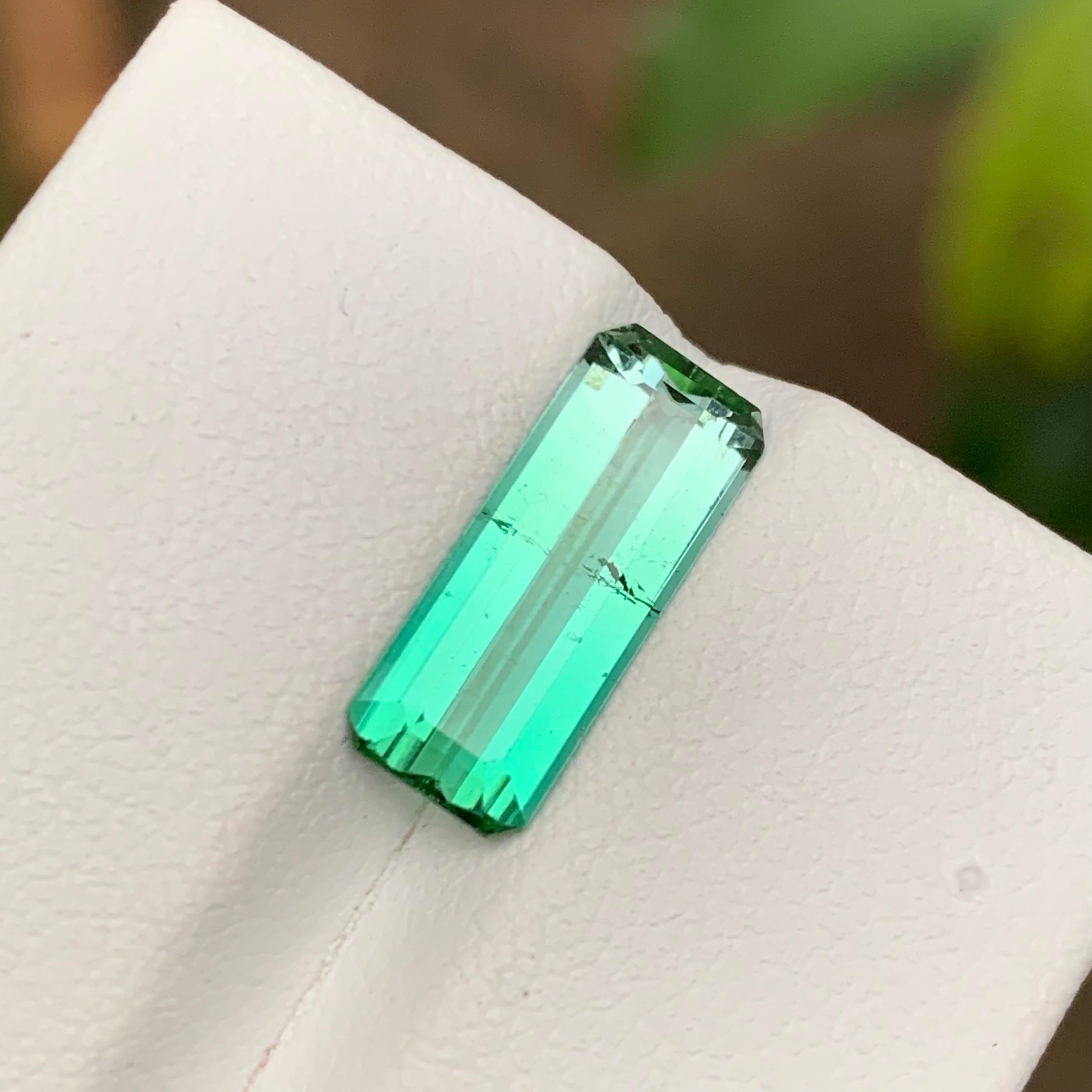 GEMSTONE TYPE: Tourmaline
PIECE(S): 1
WEIGHT: 2.90 Carats
SHAPE: Emerald
SIZE (MM): 14.45 x 5.84 x 3.73
COLOR: Neon Bluish Green
CLARITY: Slightly Included 
TREATMENT: None
ORIGIN: Afghanistan
CERTIFICATE: On demand

Introducing our exquisite 2.90