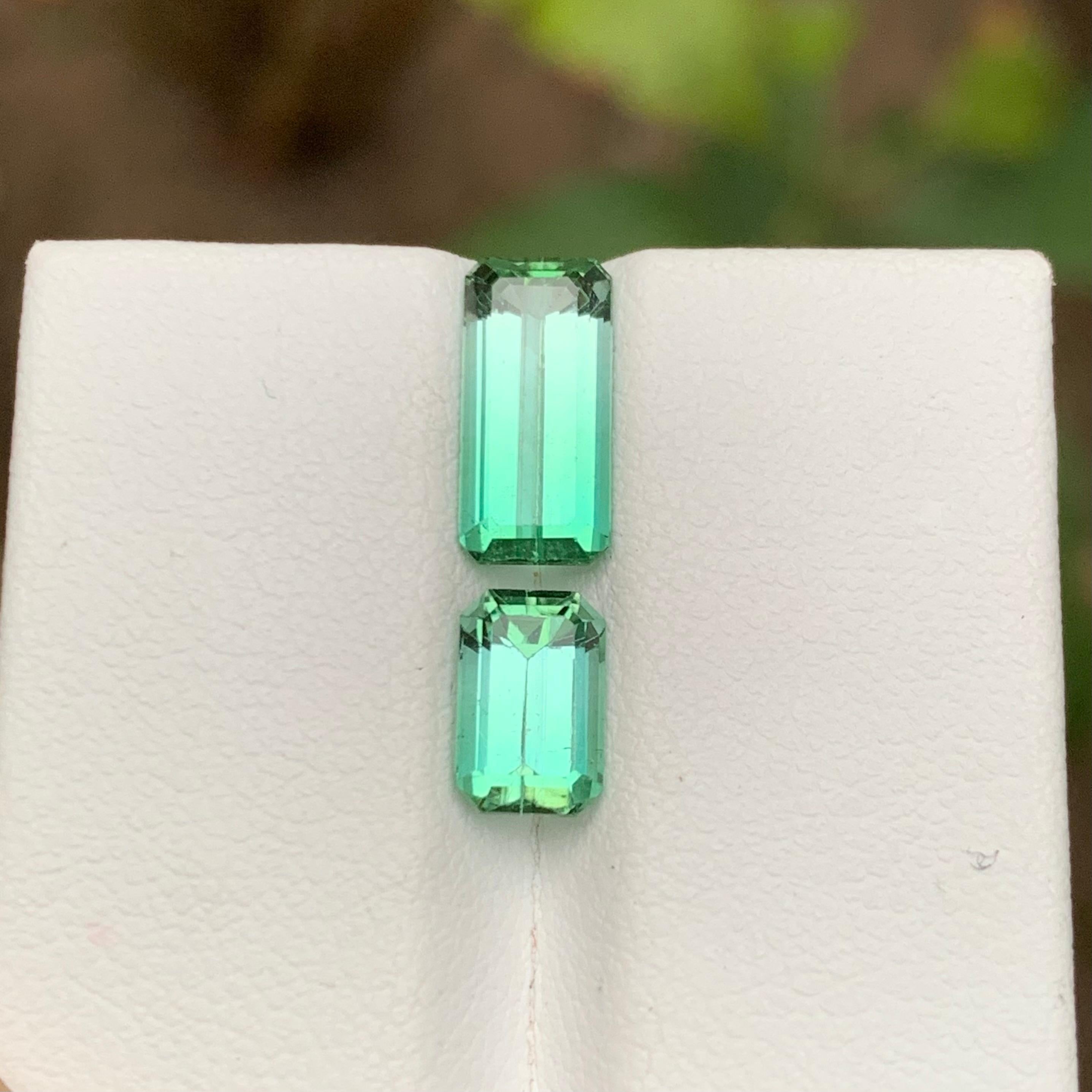 GEMSTONE TYPE: Tourmaline
PIECE(S): 2
WEIGHT: 3.55 Carats
SHAPE: Emerald
SIZE (MM): 
2.20 Carat: 11.07 x 5.23 x 4.07
1.35 Carat: 7.69 x 4.99 x 4.15
COLOR: Neon Bluish Green
CLARITY: Slightly Included 
TREATMENT: None
ORIGIN: Afghanistan
CERTIFICATE: