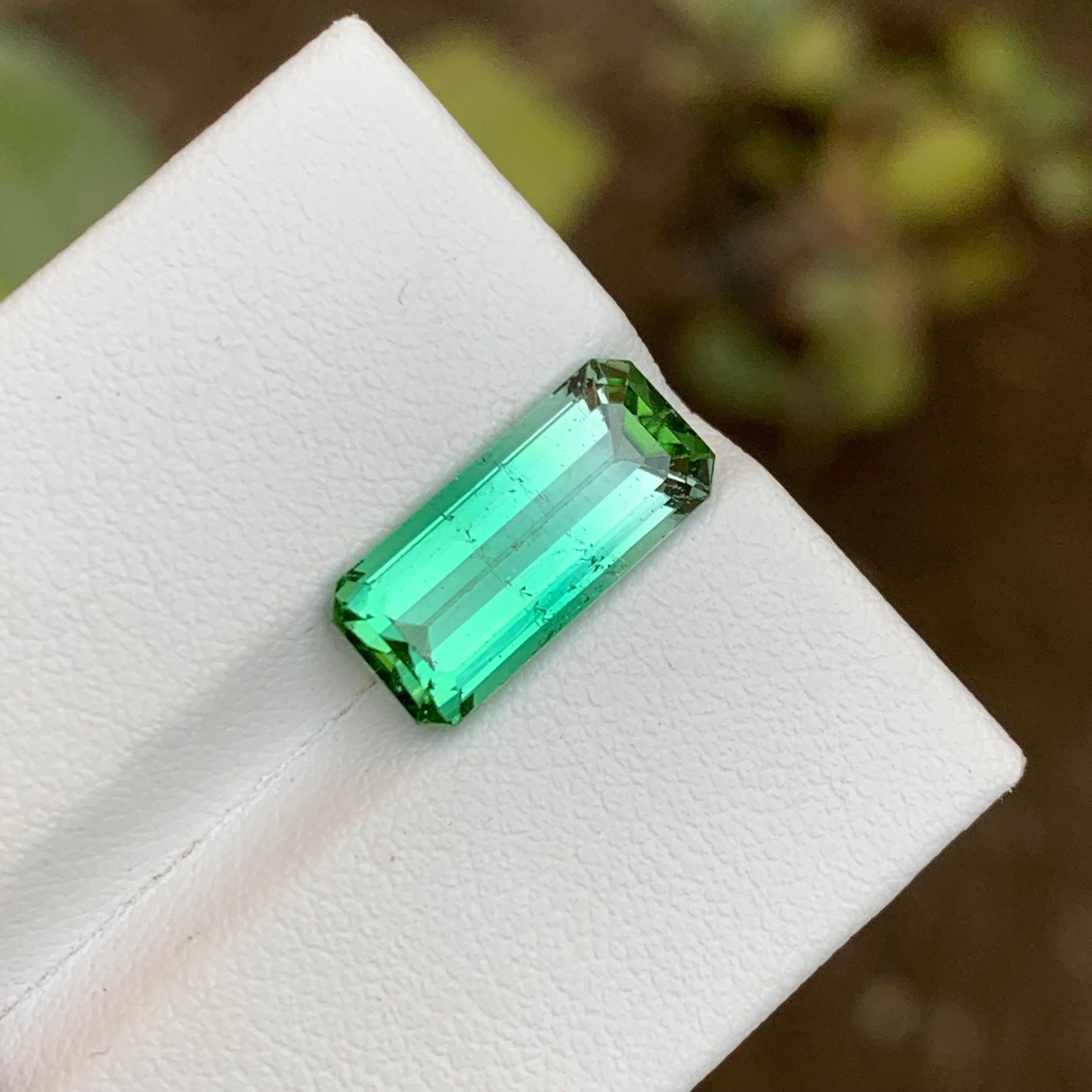 GEMSTONE TYPE: Tourmaline
PIECE(S): 1
WEIGHT: 4.40 Carats
SHAPE: Step Emerald
SIZE (MM):  14.05 x 6.61 x 5.27
COLOR: Neon Lagoon Green Bicolor
CLARITY: Slightly Included 
TREATMENT: None
ORIGIN: Afghanistan
CERTIFICATE: On demand

This dazzling 4.40