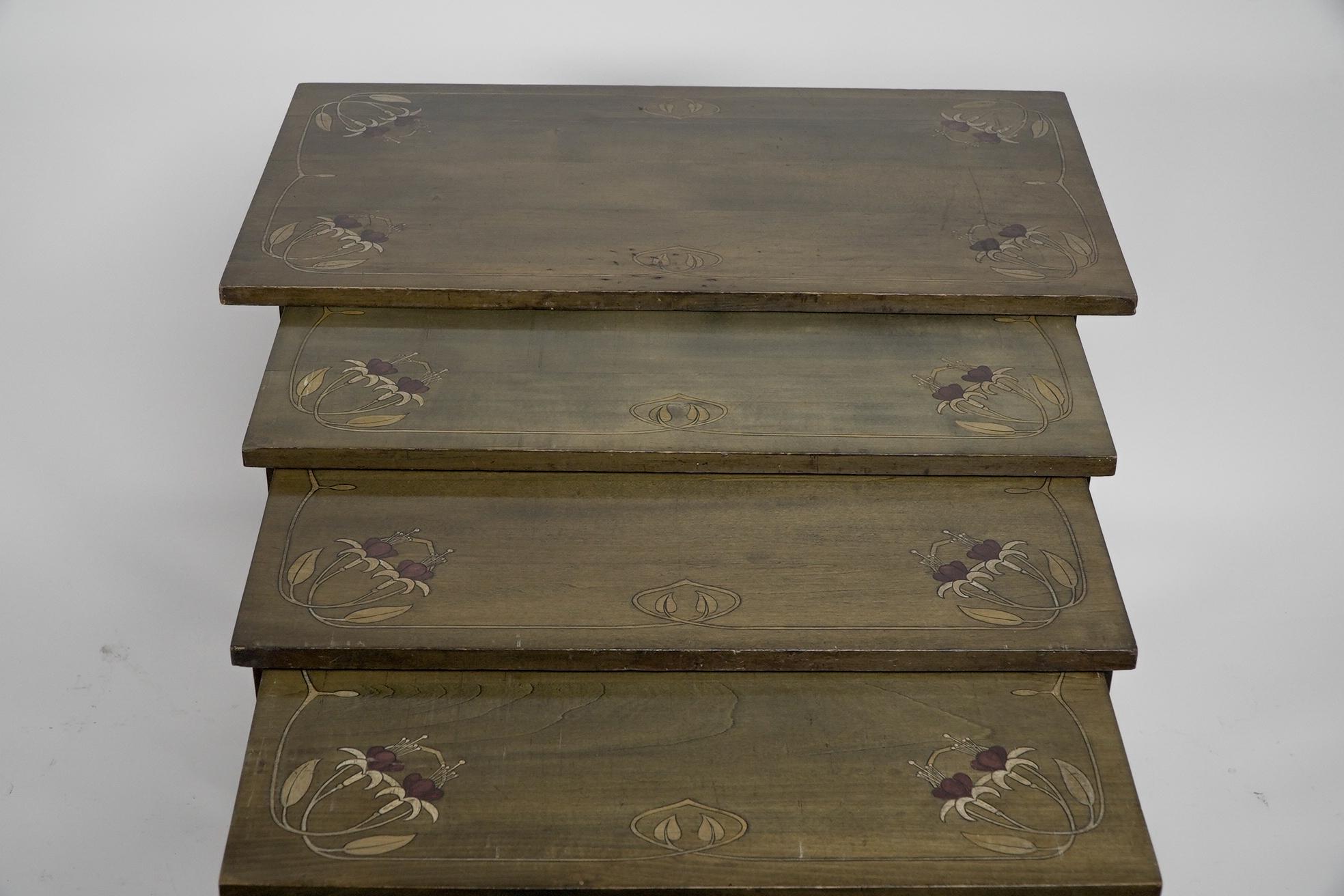 A nest of four side tables each top surface hand painted with floral decoration. In Good Condition For Sale In London, GB
