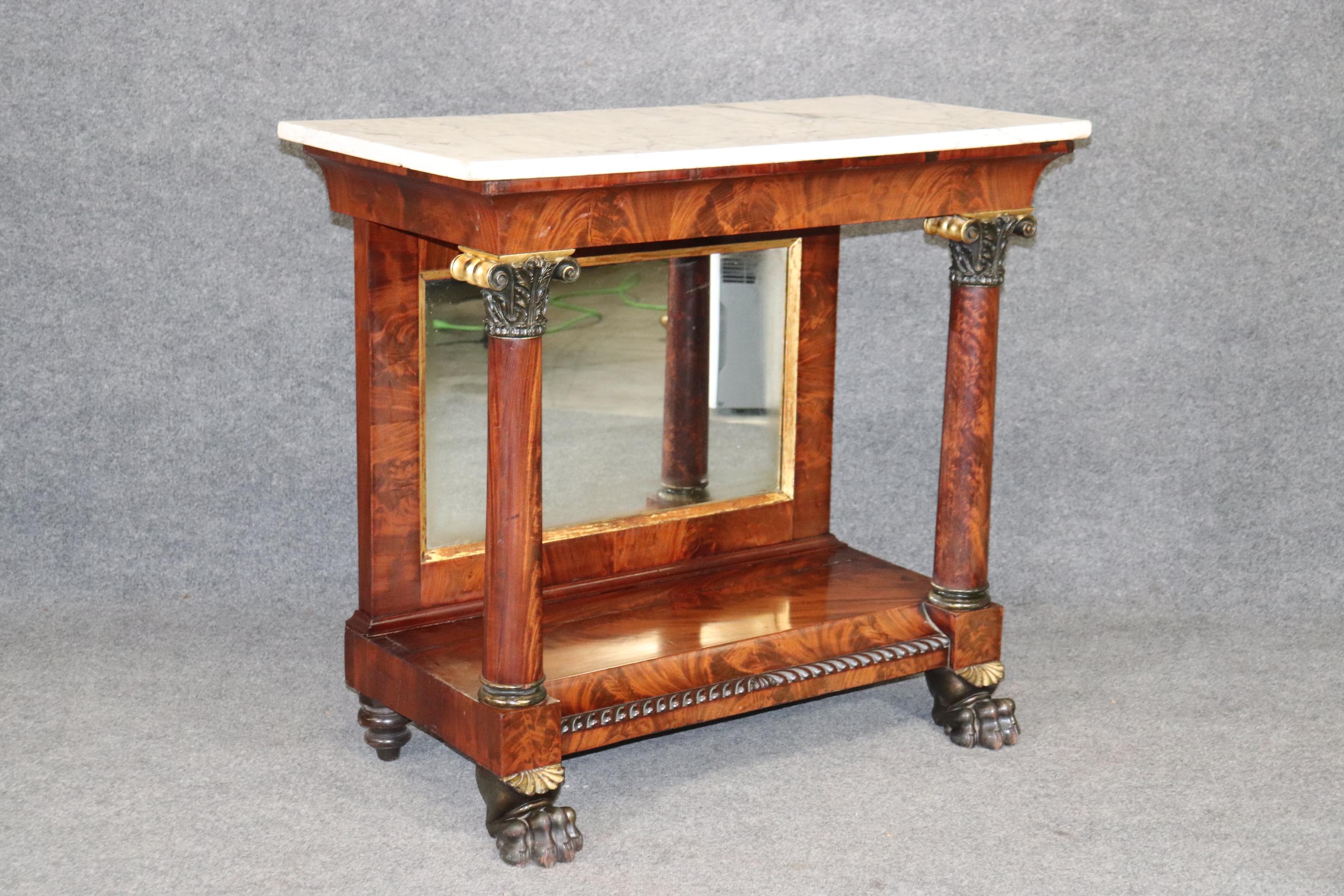 This is a gorgeous flame mahogany pier table that is either from New York City or perhaps Philadelphia. The table is fitted with beautifully carved paw feet and a nice original marble top. The table is from teh 1830-1840s era. The table will have