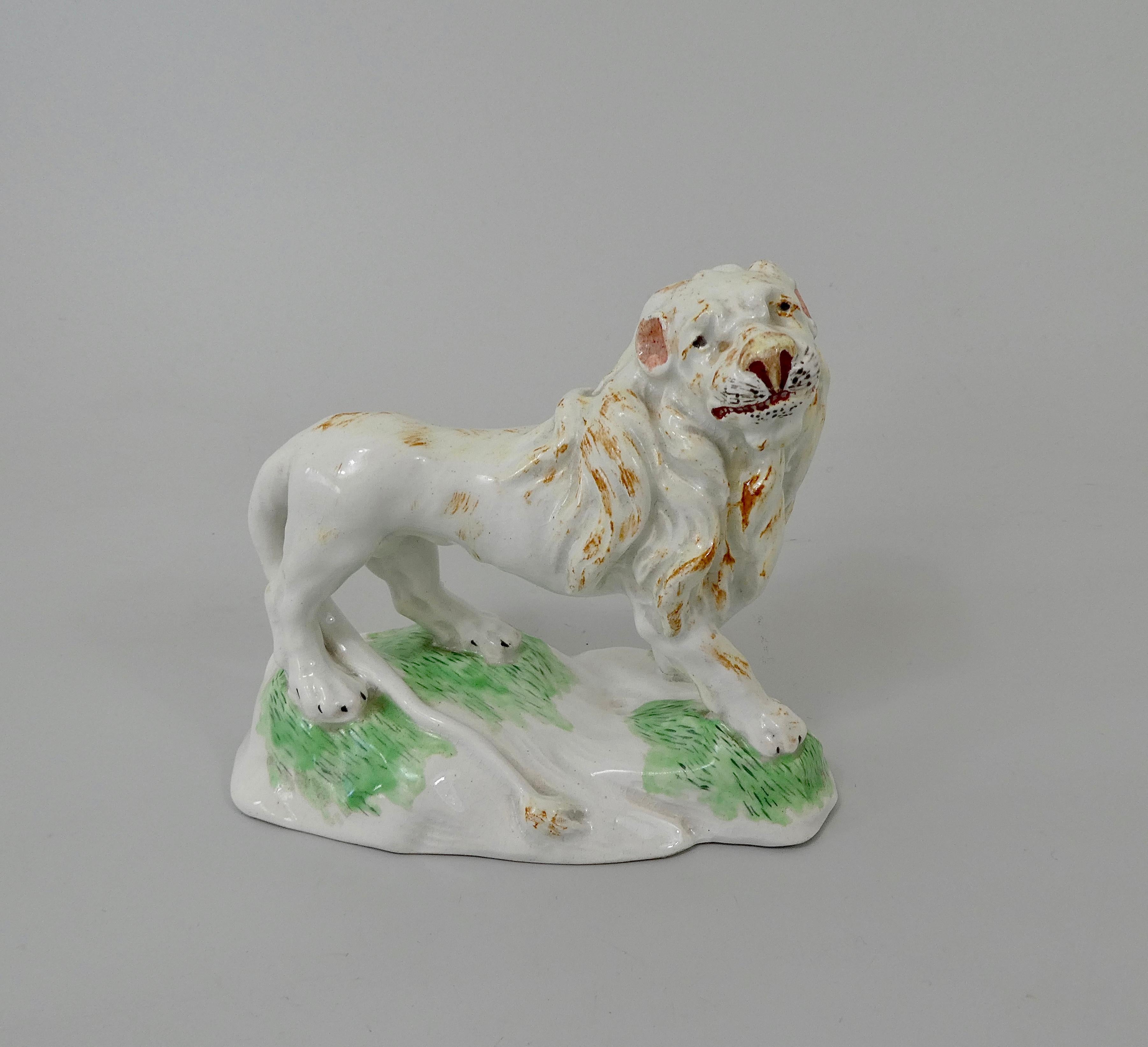 Rare Niderviller Faience figure, Count Custine period, circa 1780. Finely modeled as a standing lion, the head and mane being particularly well defined, along with an incongruously long tail.
Set upon an irregular mound base, the painting of the
