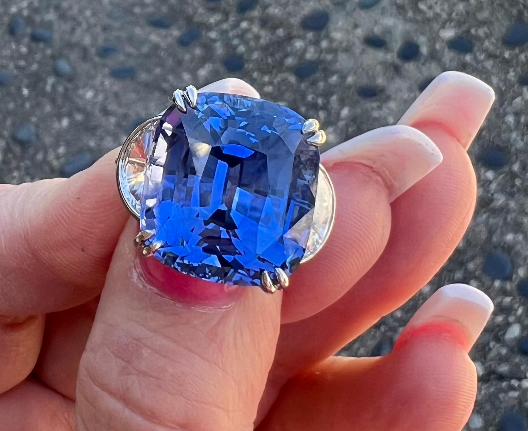 Stupendous and very significant, 33.77 carat estate GIA Certified huge brilliant cut natural corundum blue sapphire and diamond three stone ring is set in platinum. This is a very noteworthy and very collectible natural sapphire with no indications