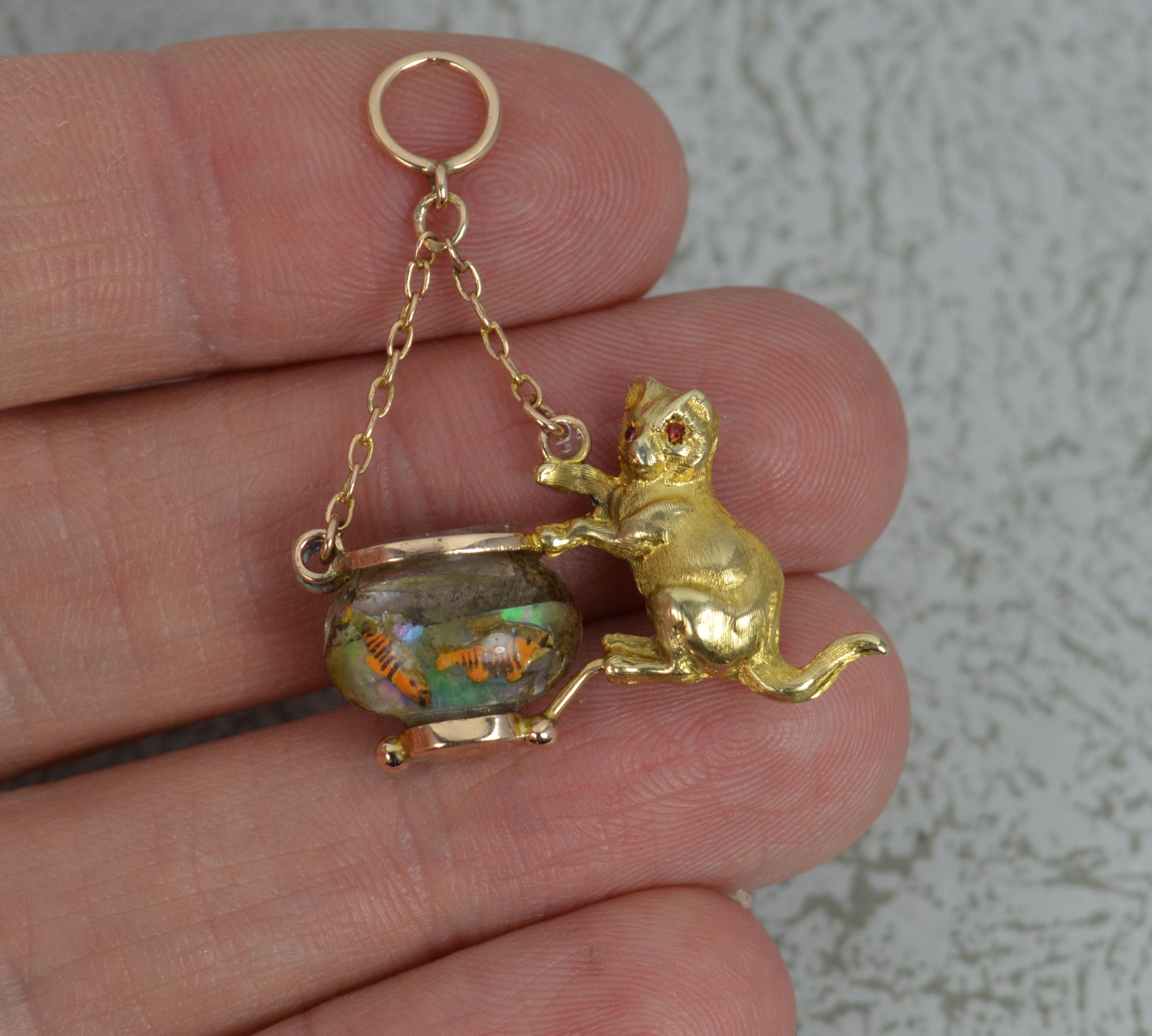 A highly unusual novelty charm pendant.
True antique piece, circa 1920.
Solid 9 carat rose gold example with glass fishing bowl.
Designed as a cat with one paw reaching up towards the two fish. On a lavalier chain pendant.

CONDITION ; Good for age.