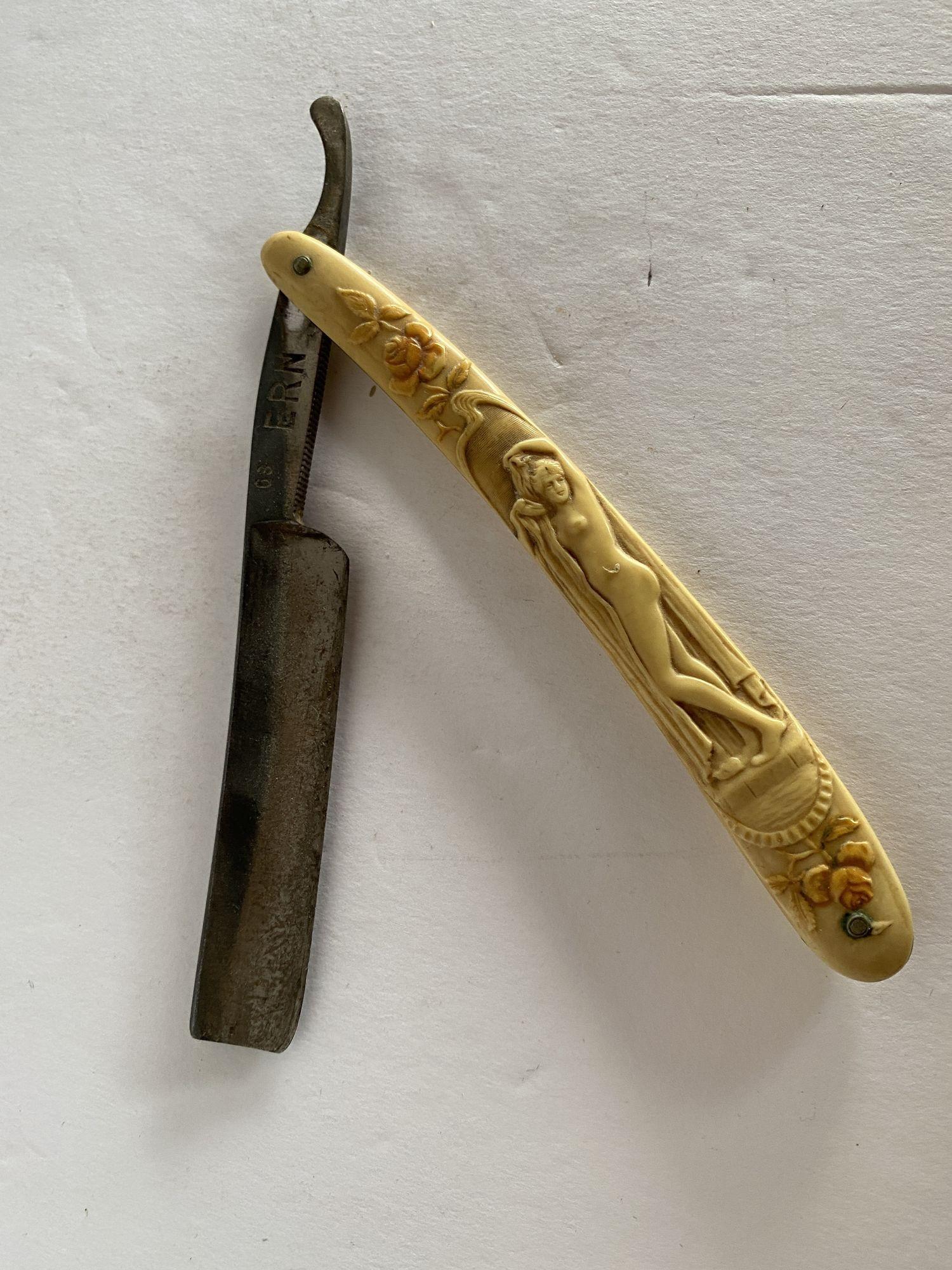 Rare nude Art Nouveau celluloid handle Straight Razor. This is a great antique straight razor with a detailed Art Nouveau Nude standing in a greek setting leaf carved into the handle. Some of the original coloration (pink and green) is still