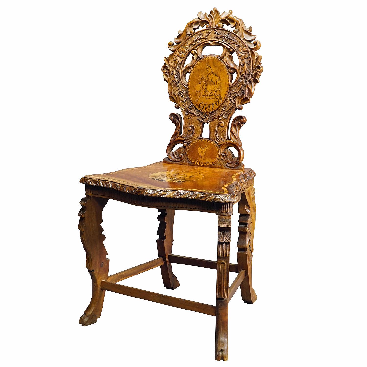 Rare Nutwood Edelweis Marquetry Chair Swiss Brienz 1900

A very nice antique Swiss nutwood chair decorated with inlayed and painted sceneries depicting ibex and chamois. The backrest is additionaly decorated with elaborate edelweis flower carvings.