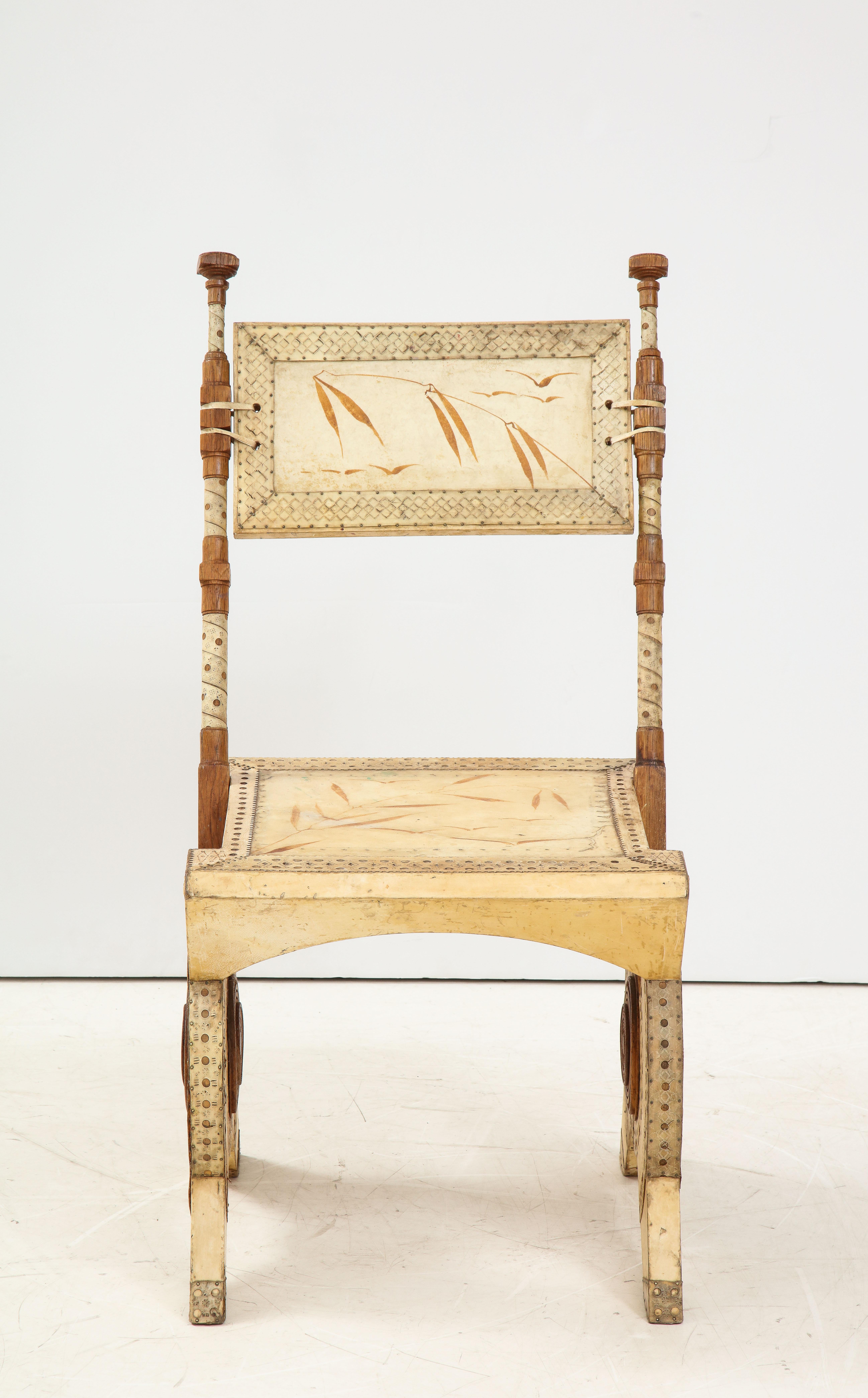 Rare oak and parchment chair by Carlo Bugatti han painted with birds and leaves motifs. 
Marked to underside ‘Mobili Brevettat Bugatti. Italy: circa 1904
Carlo Bugatti was a famous designer active at the turn of the century. His pieces are rare