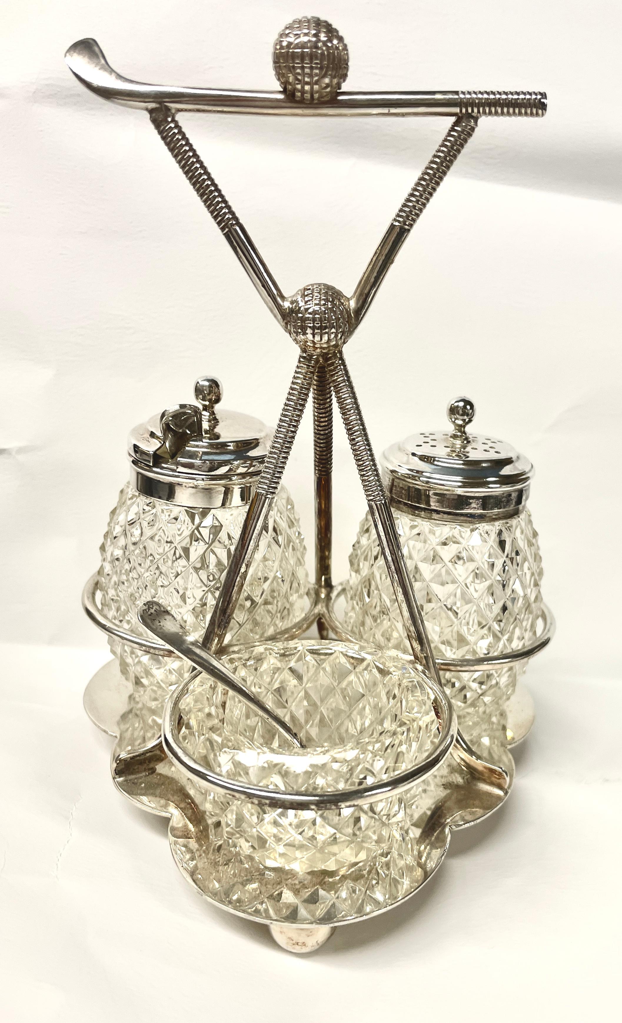 Rare old English silverplate golf motif novelty breakfast cruet. The set includes an open salt cellar with spoon, a mustard pot with spoon and a pepper pot. Please note the use of golf clubs as supports and the hand cut crystal original bottles are