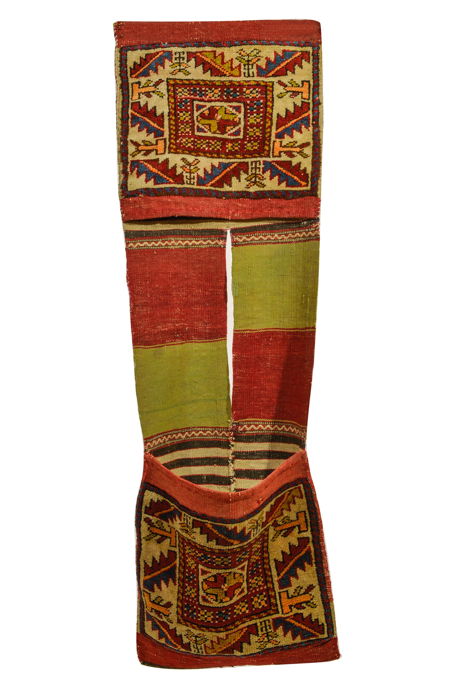 nr. 946 - Old Shahsavan saddle bag, with interesting design and beautiful colors: border with leaves and little trees, central part Kilim with alternating colors red and pea green.
Suitable on wall (horizontal)  like a painting or on a LITTLE  BENCH