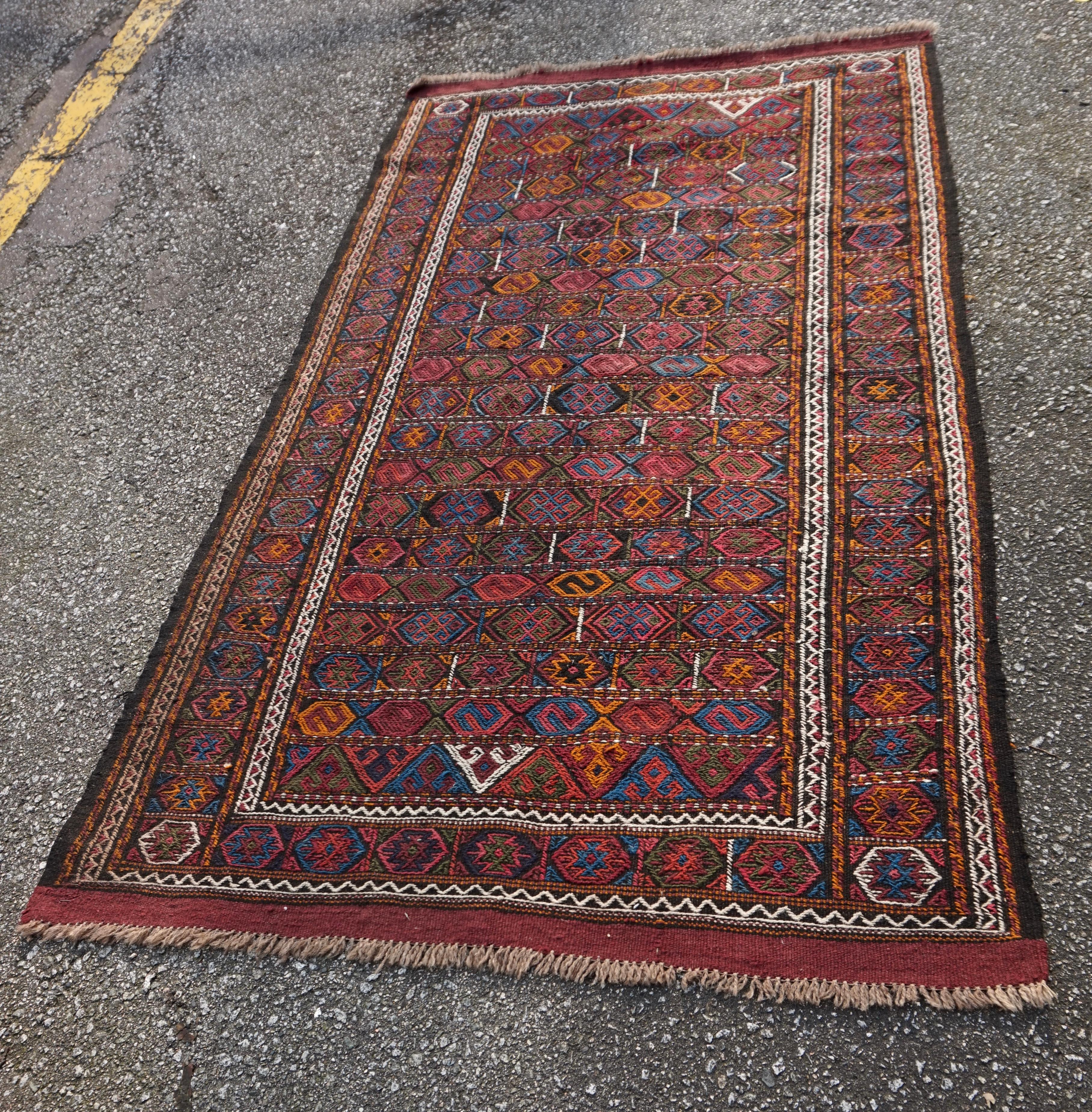 Rare Central Asian nomadic tribal kilim with exquisite flat-weave. A refined medley of warm, yet subdued hues define this rustic piece. Some minor repair present but overall in very good condition.