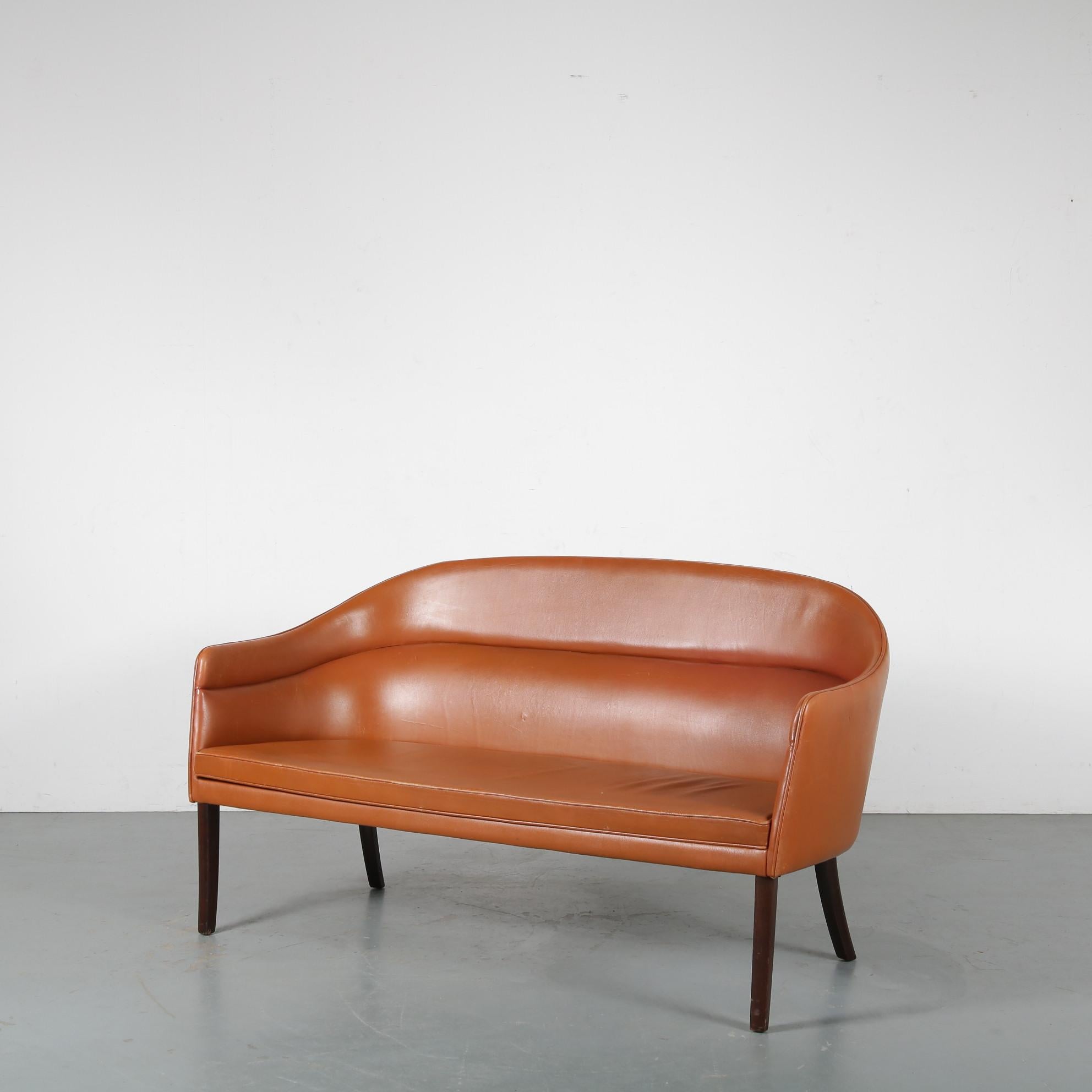 An outstanding, very rare 2-seater sofa designed by Ole Wanscher, manufactured by J. Jeppesen in Denmark around 1950.

This impressive piece is really well made by on of the greatest Danish designers. It has elegant, tall wooden legs and the seat