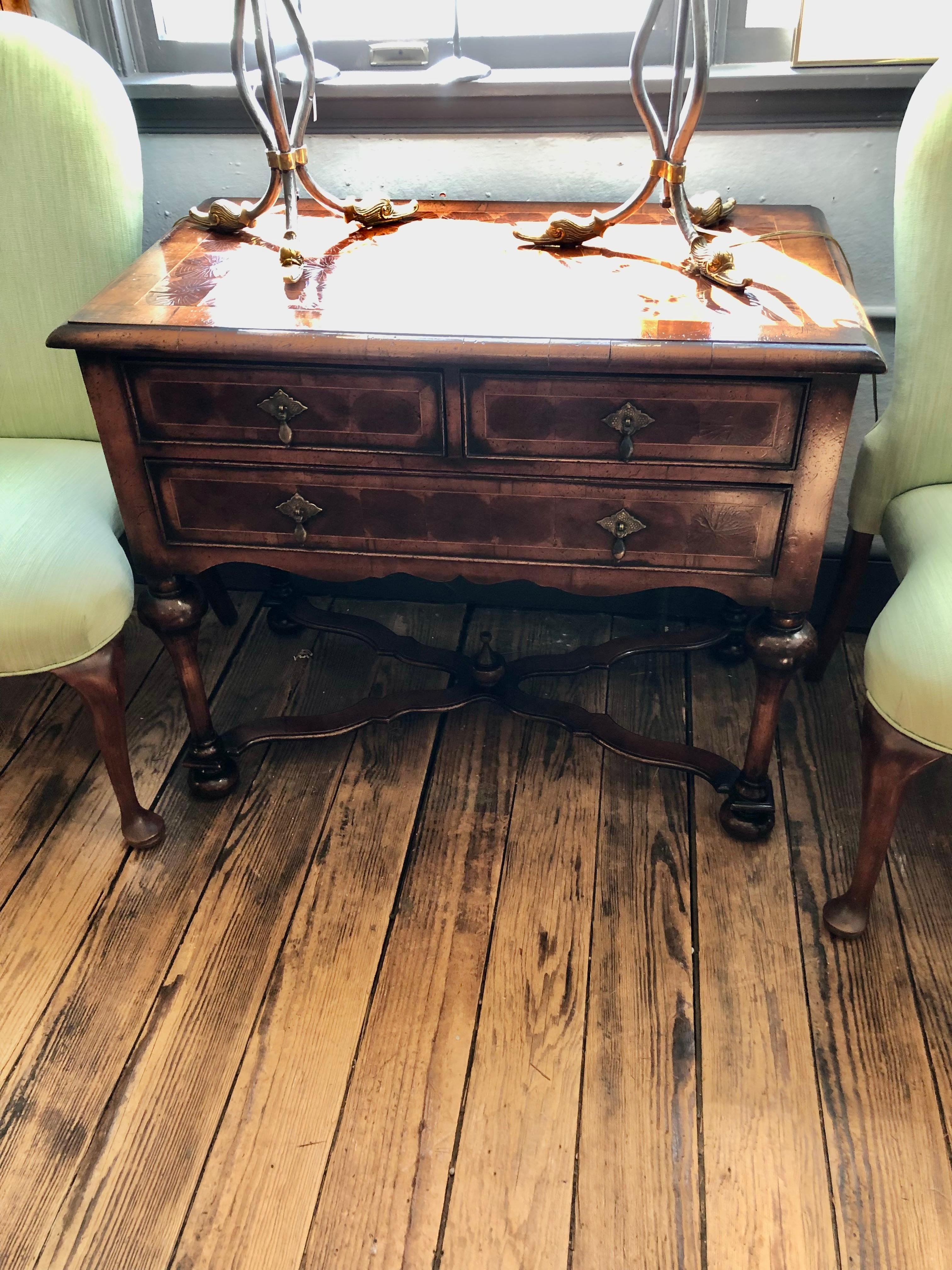 Gorgeous and unusual oyster wood lowboy chest of drawers having richly inlaid top with aged patina and craquelure.  3 drawers and handsome matte brasses as well as turned legs and stretcher with decorative finial.