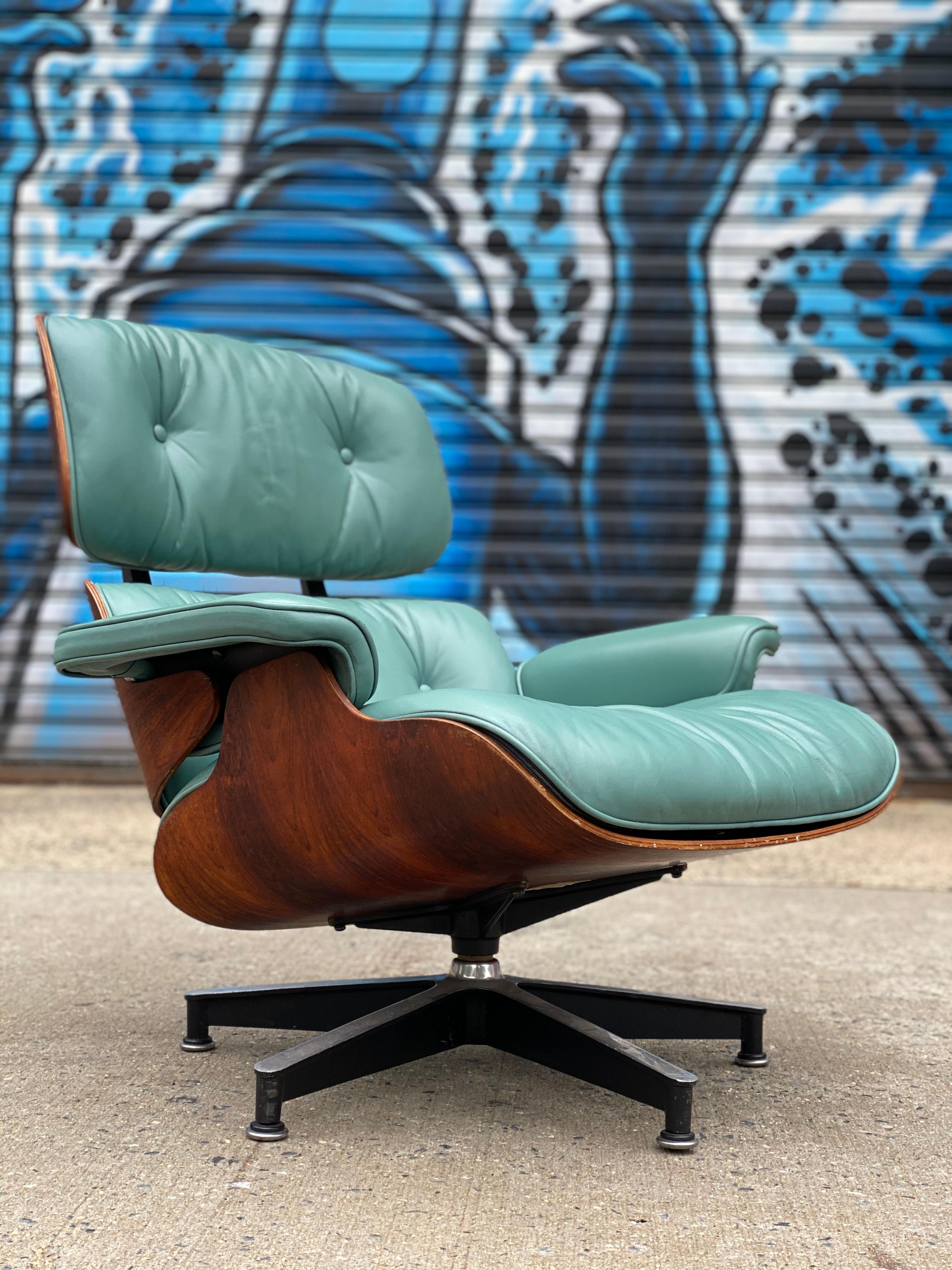 Incredibly vibrant and elegant edition of the classic Herman Miller Eames lounge chair and ottoman, circa 1960/1970s chair with original Herman Miller label. Custom leather cushions in superb condition. This blue green is not a color we have ever