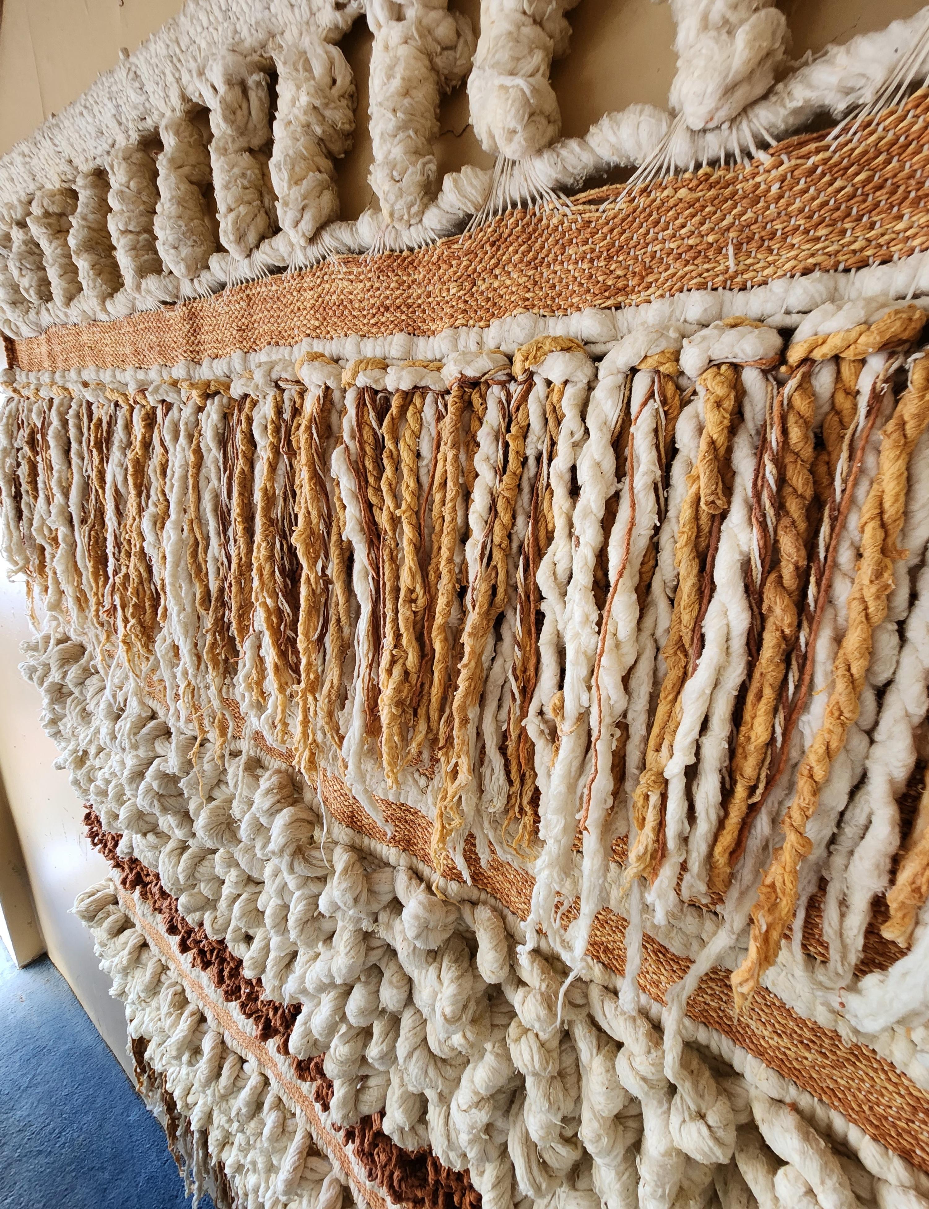 This is a fabulous vintage x-large wool wall hanging from the Late Mid-Century Modern era. Artesian and handmade this piece is one of a kind! The woven wool and fibers are neutral in color with white, cream, tan, peach and rust colors. The texture