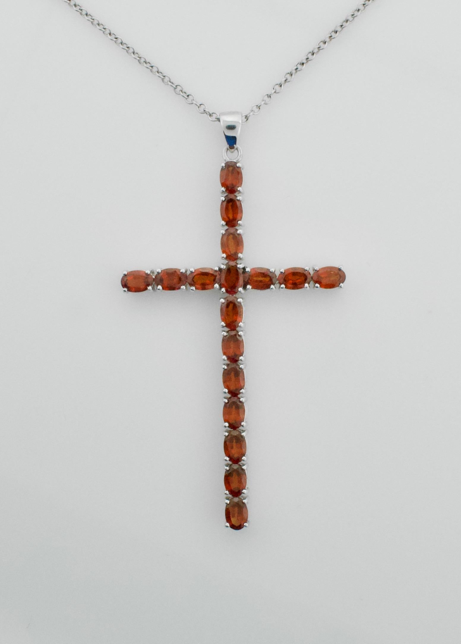 Rare Orange Garnet Cross Necklace 8.75 carats  in White Gold
Garnets Come in All Colors.  Orange if very unusual 
Fourteen Oval Cut Garnets weighing 8.75  carats approximately [bright with no imperfections visible to the naked eye]
On a 17 1/2 inch