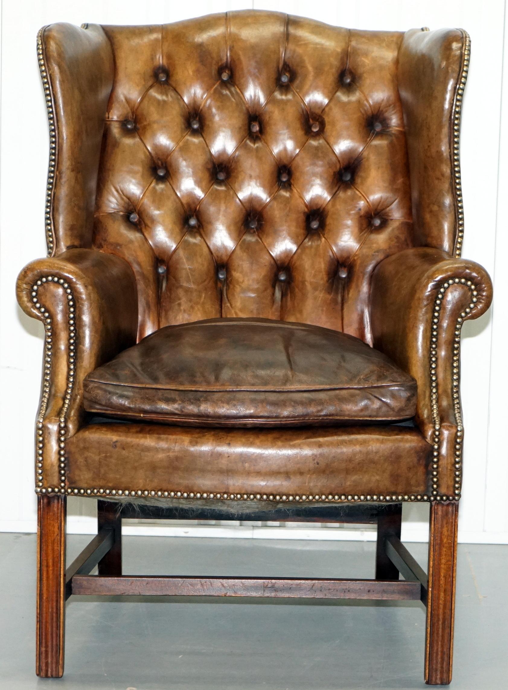 We are delighted to offer for sale this lovely original 1930s Chesterfield aged leather feather cushion base wingback armchair with Georgian style H-Frame

I have a similar fully button base version of this chair listed under my other items,