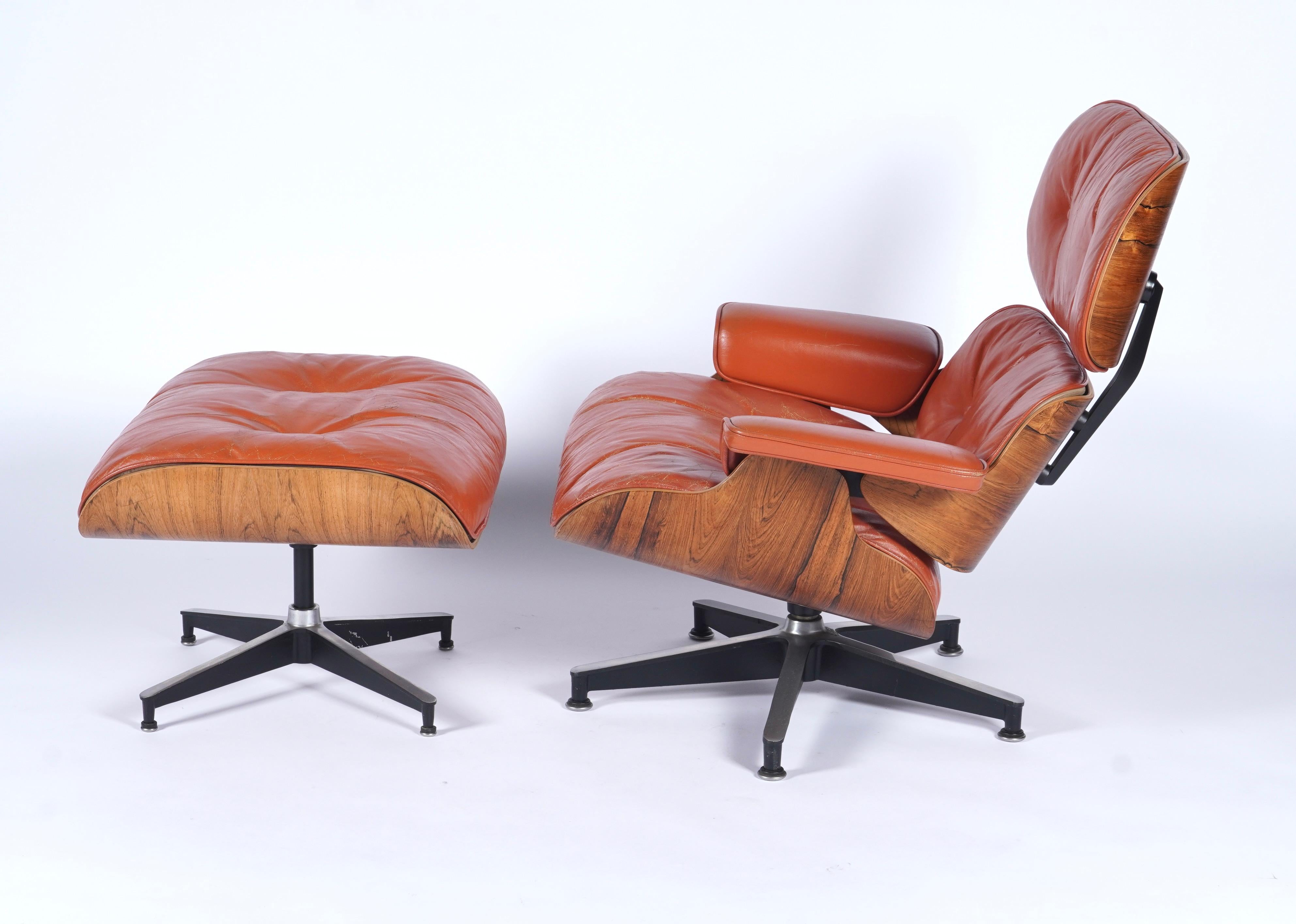 Beautiful all original example of a 1960s custom order Eames lounge chair and ottoman (670 & 671), with a burnt orange color to the leather with foam and feather fill. The shells are of Brazilian rosewood with both lighter and darker graining which