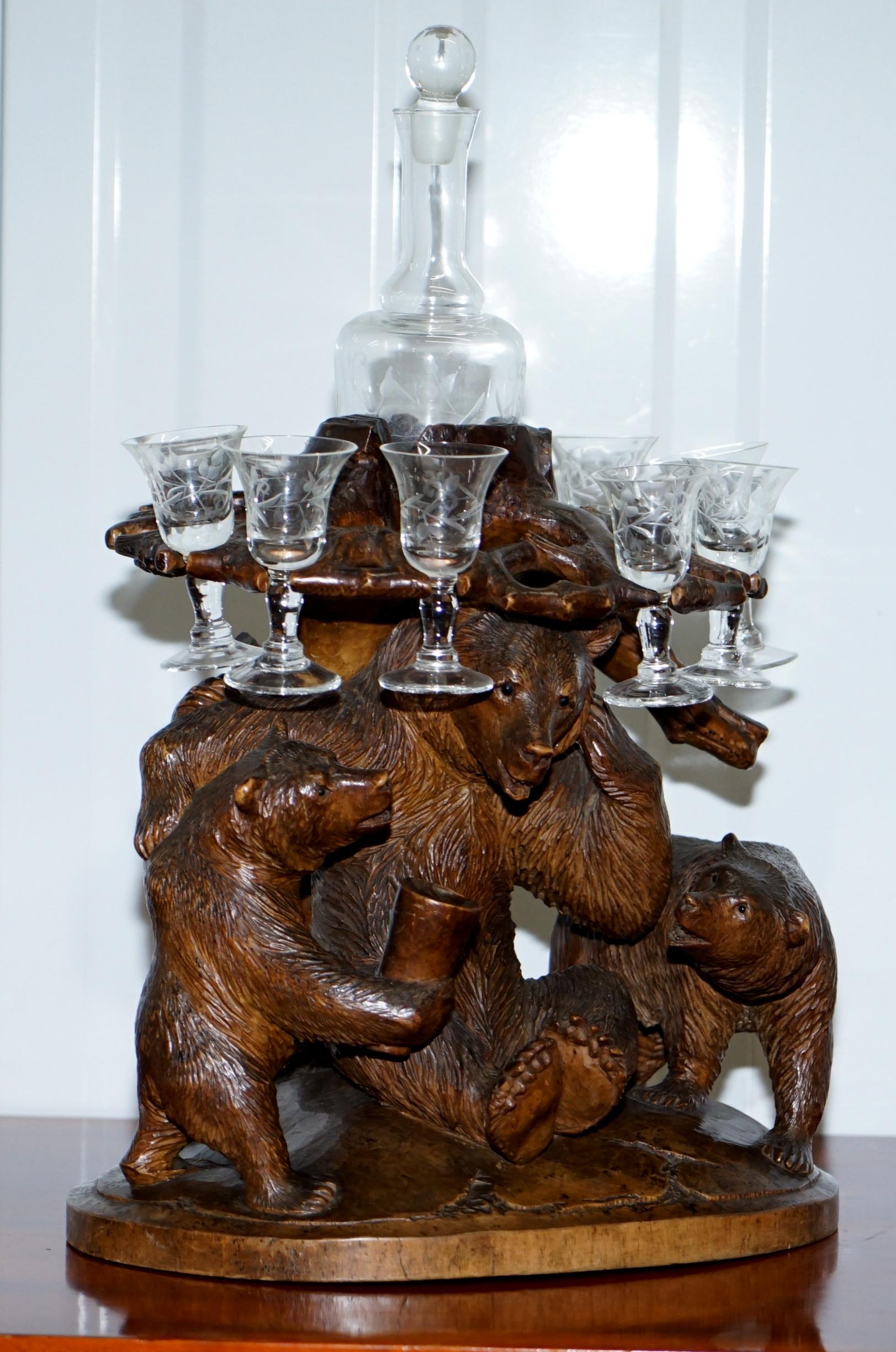 We are delighted to offer for sale this very rare circa 1900 Black Forest wood Tantalus table drinks decanter suite with three bears

This tantalus table, a receptacle for holding a decanter, is a folly of a piece. The base is decorated with three