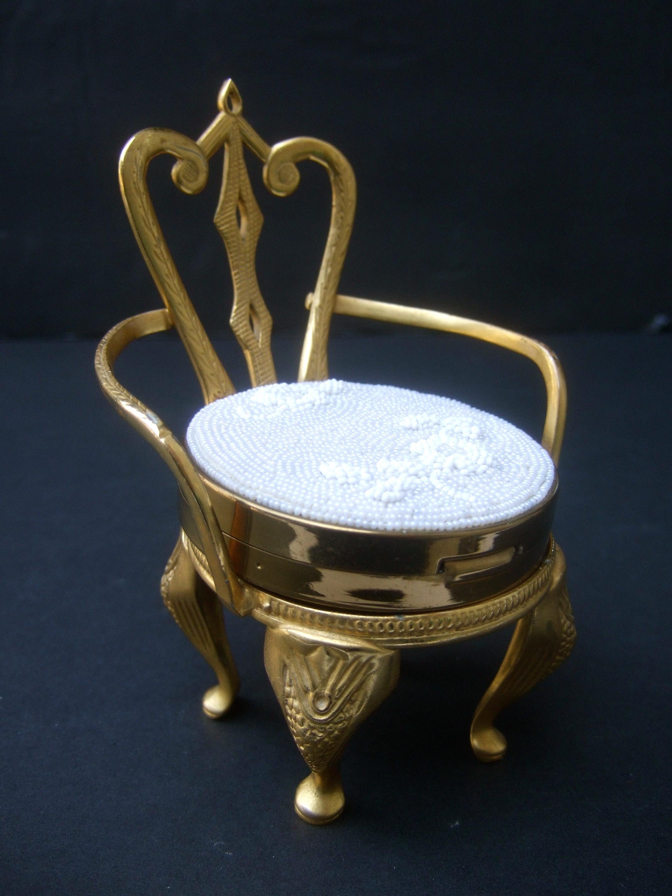 Rare Original by Robert' Vanity compact chair collectible c 1960
The glass beaded vanity compact rests upon a charming diminutive 
gilded brass metal chair. The tiny chair has impressed designs
that run down the legs & extend to the backside

The