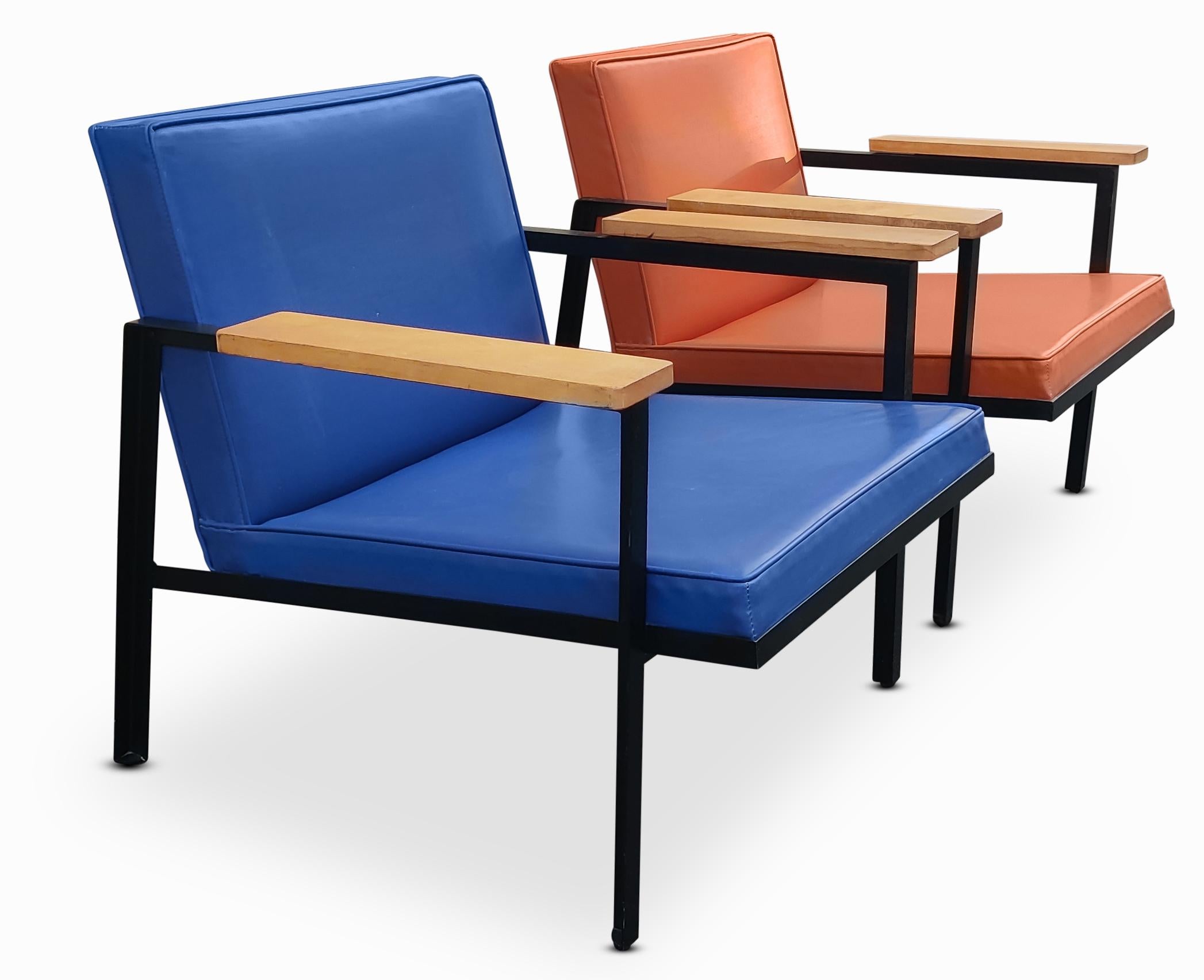 Super rare! George Nelson for Herman Miller steel frame chairs, model 5080 Easy Lounge Chairs. Original painted frames with solid wood arms. Original blue and orange vinyl upholstery. Vinyl is soft and pliable, minor blemishes on each. Padding is