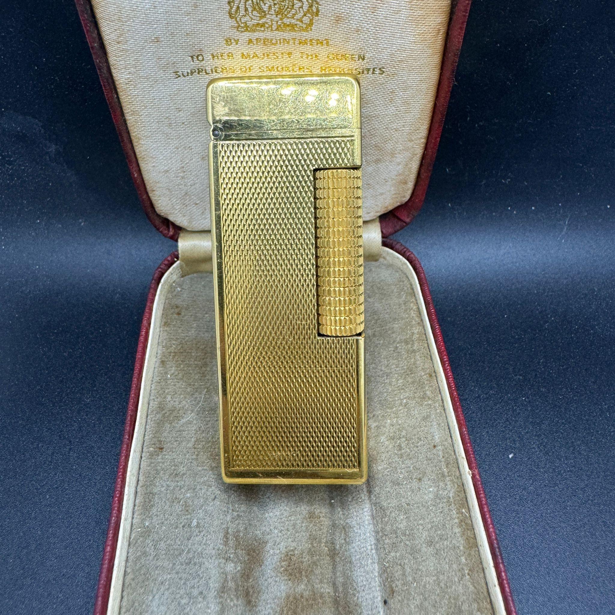 This Rare Original James Bond Vintage 1970s Dunhill ROLLALITE Gold Plated Lighter 
In Mint Working condition 
In the original British Red Sky Case with the Luxury red Velvet interior
The lighter is gold plated and in excellent condition 
There is an