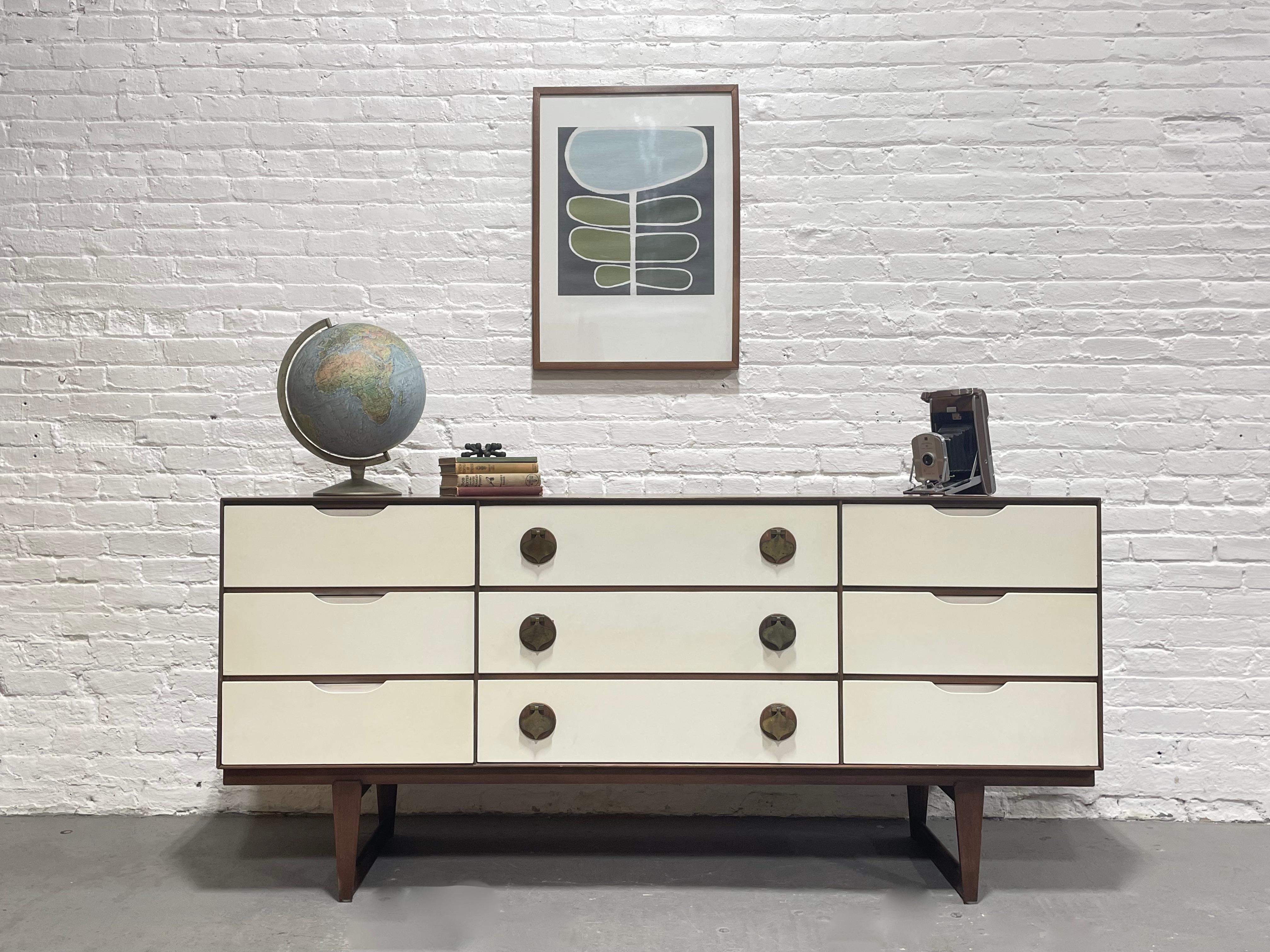 Rare + Original Mid Century Modern White & Walnut Long Dresser by Stanley Furniture Co., c. 1960's. This elusive series was in limited production and is incredibly hard to find. The dresser is highlighted by solid brass spade pulls over solid walnut