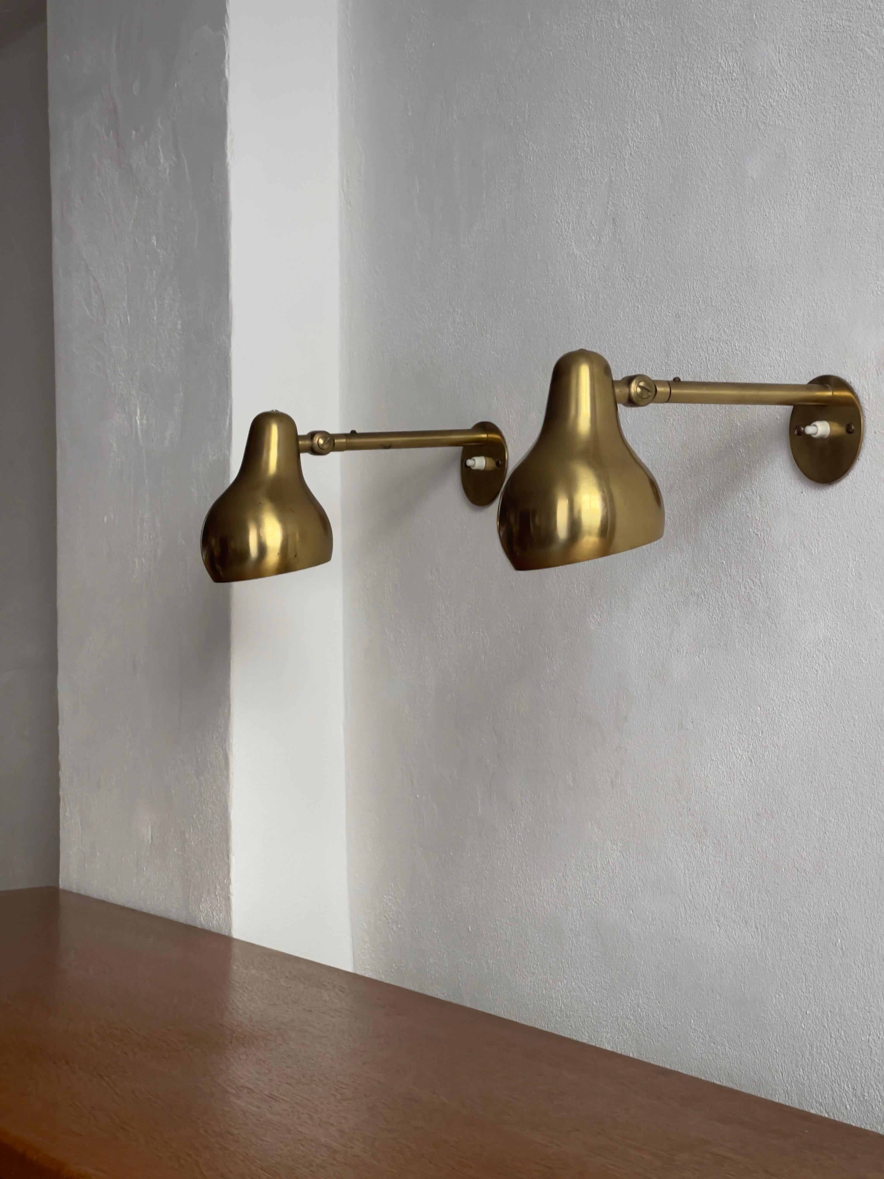 We have the privilege of showcasing a rare, original pair of 1940s Wilhelm Lauritzen wall lights crafted in patinated brass and manufactured by the renowned Danish lighting company, Louis Poulsen Denmark 1940s.

Designed for both form and function,