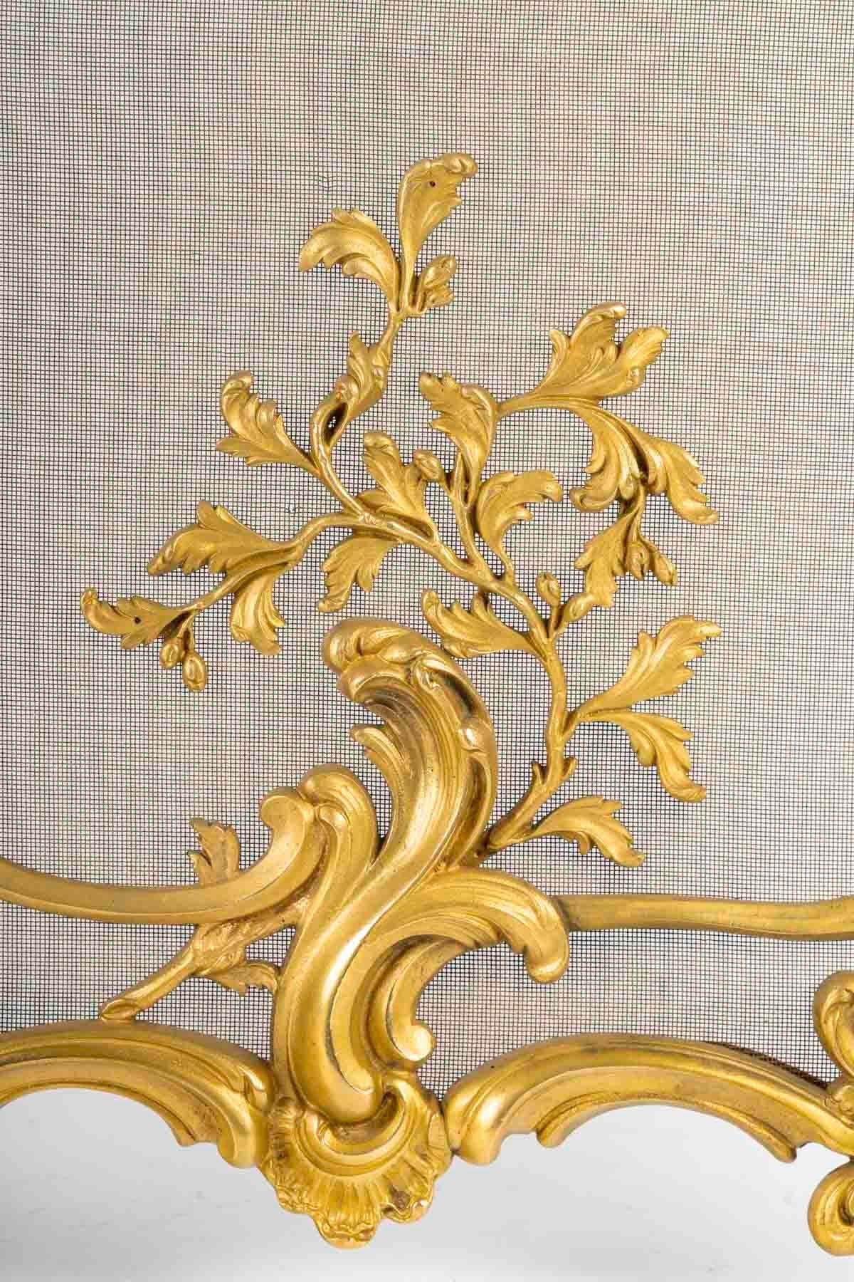 Rare ormolu fire screen in the Louis XV style.

Rare Napoleon III period gilded bronze fire screen, very fine quality fireplace front in the Louis XV style, 19th century.
H: 75cm. W: 75cm, D: 22cm