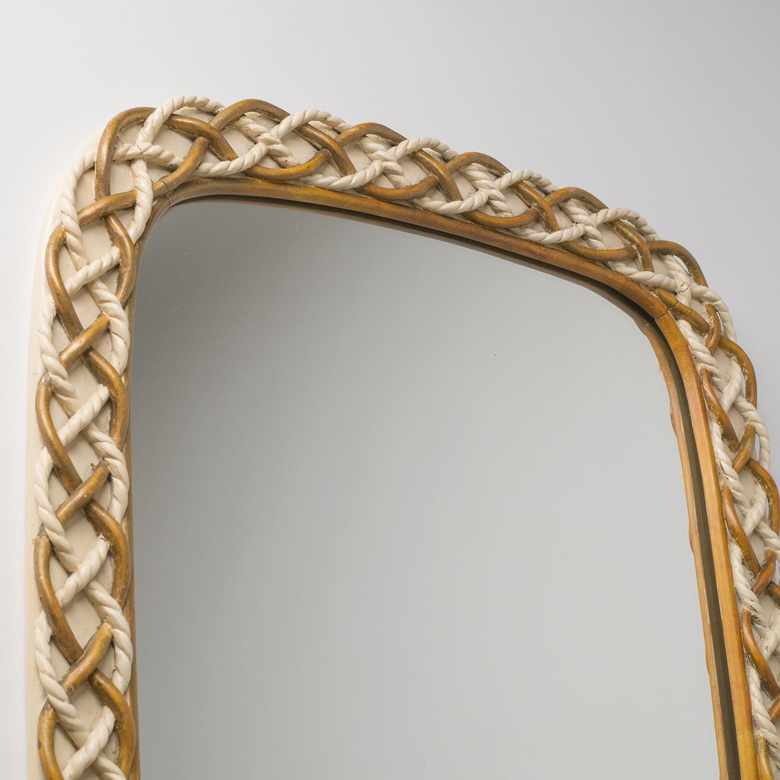 Rare Italian carved wood mirror designed by Osvaldo Borsani in the 1940s. What appears to be intertwined rope is in fact entirely made of hand-carved wood, lacquered in off-white and gold. Comes with a certificate of authenticity by the Archivo