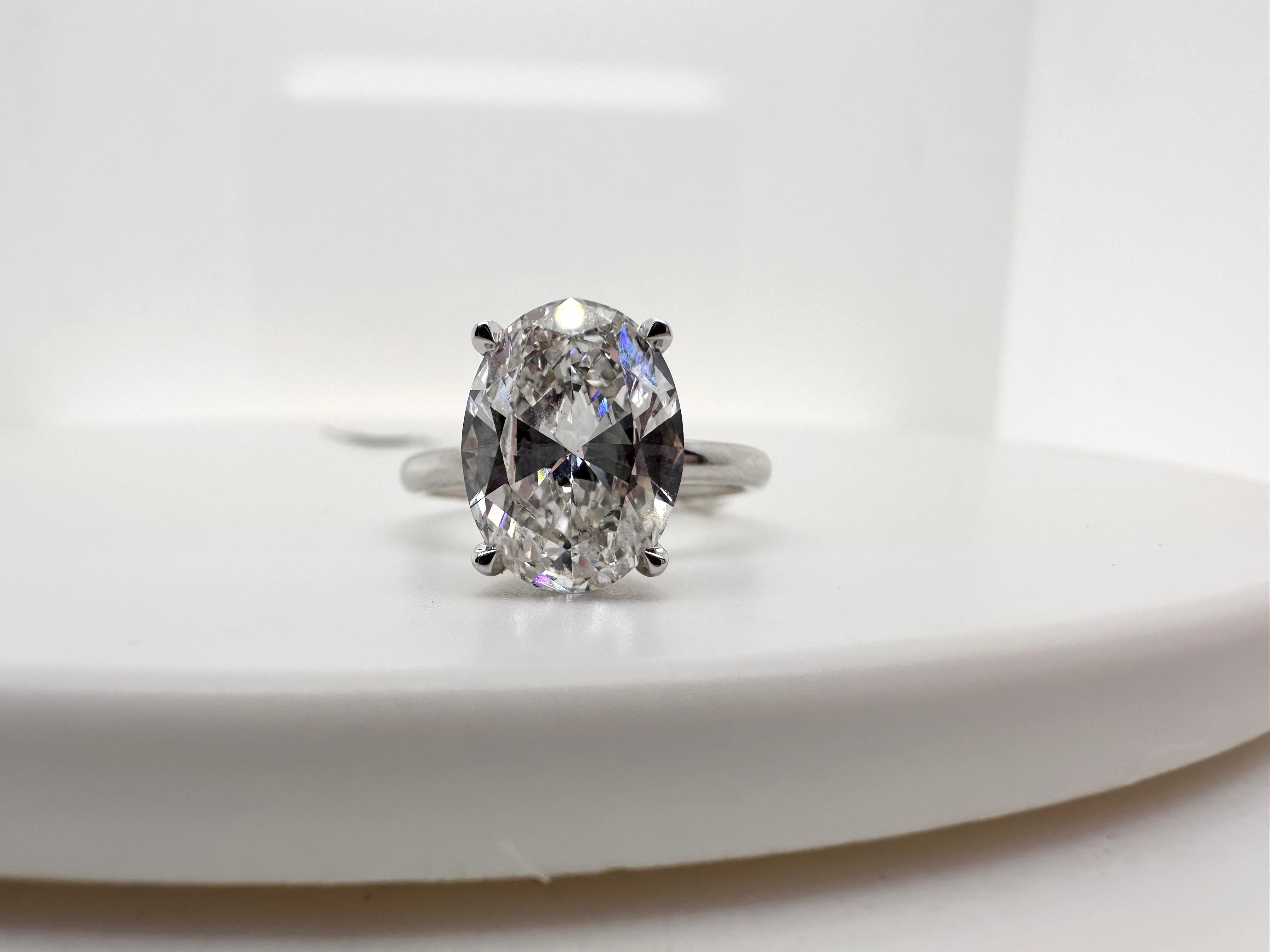 Huge oval engagement ring in 18KT white gold, the center diamond is a stunning 3.03 carats SI2 clarity and G color diamond certified by GIA. This ring is a showstopper with its brilliance yet humble classical design!

Metal Type: 18KT
Size:6
Natural