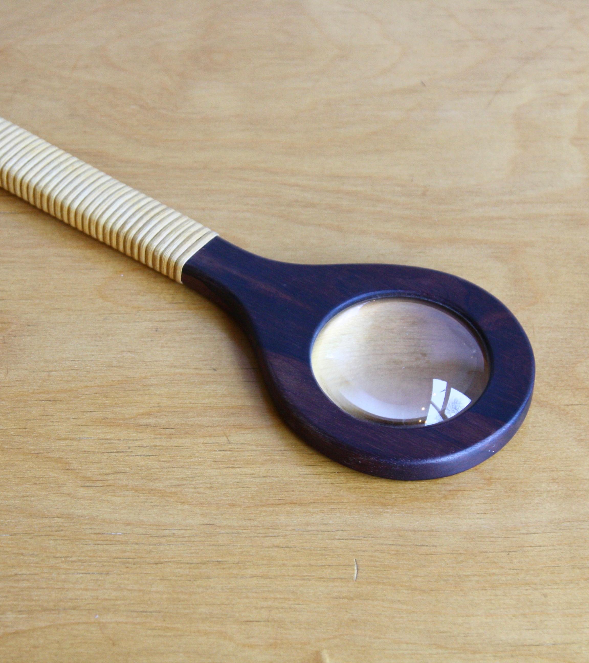 An extremely rare and charmingly eccentric oversized handled magnifying glass designed and by Carl Auböck II, circa 1950.The body of the object is carved from solid Brazilian rosewood. A large hole for the fisheye magnifying glass has been cutout