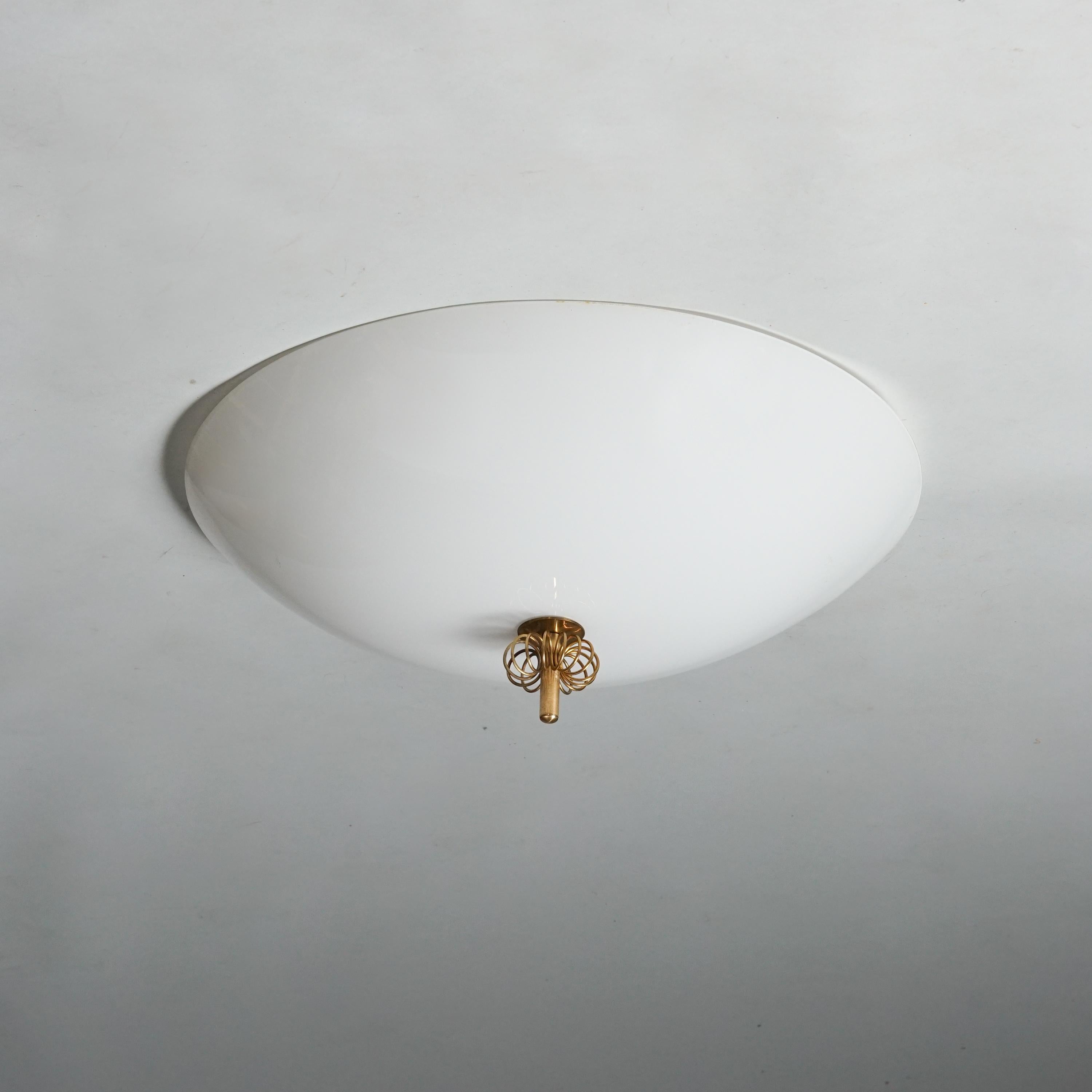 Rare Paavo Tynell Flush Mount Model 2093 in Opaline Glass and Brass. Made in Finland. Circa 1950s.
This piece gives you classic Paavo Tynell details and a beautiful light sheds through the opaline glass shade. 