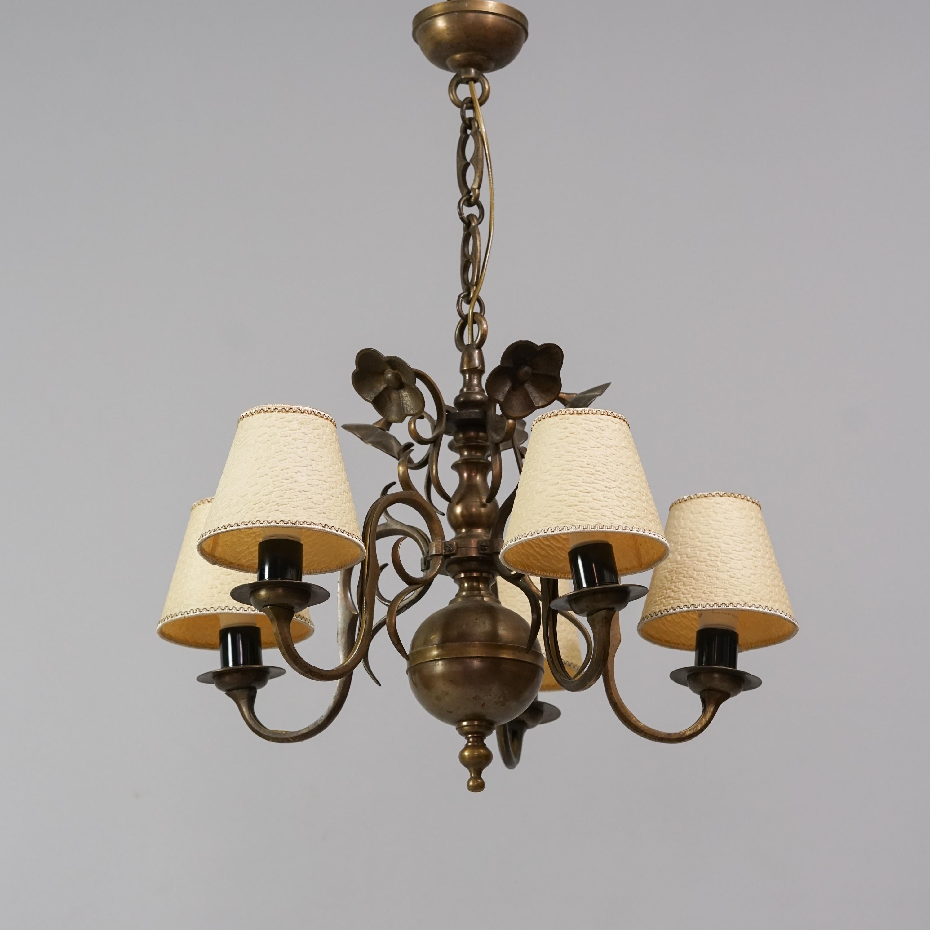 Paavo Tynell model 50488 iron chandelier manufactured by Taito oy from the 1920/1930s. Five paper lampshades. Good vintage condition, minor patina consistent with age and use. Exceedingly rare Paavo Tynell design. Intricate flower details.