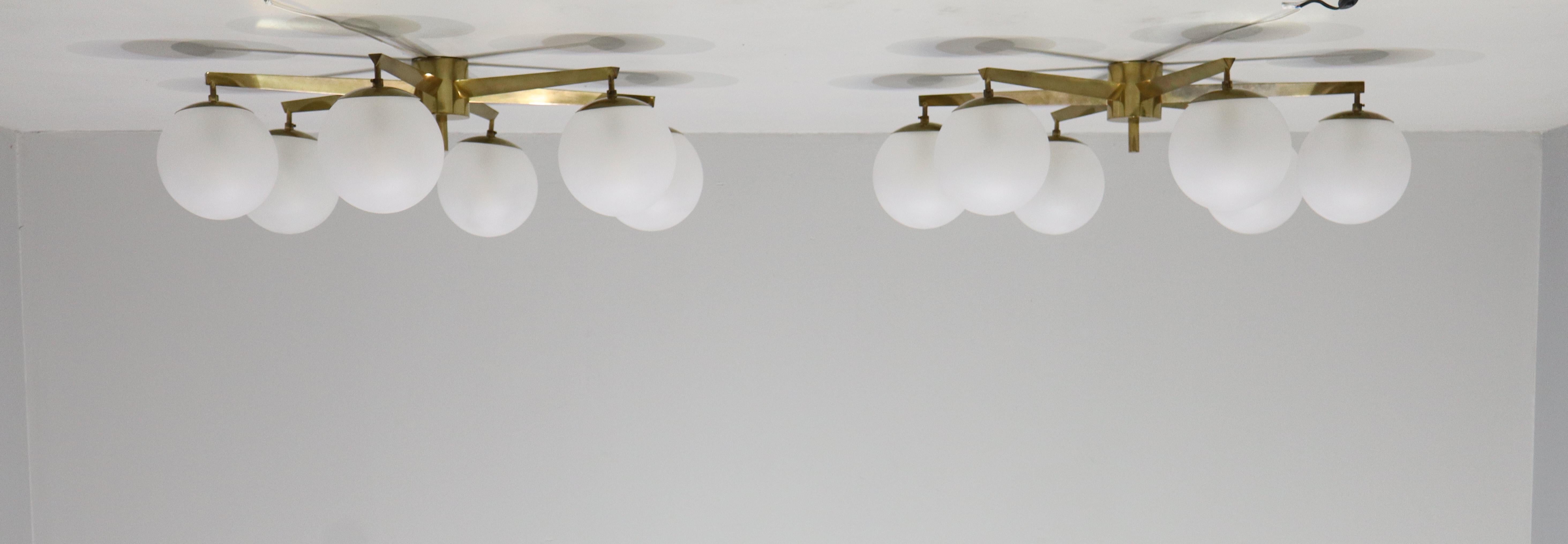 Angelo Lelli for Arredoluce rare Pair original Stella flush mount ceiling light or chandelier with with six acid-etched glass globe shades suspended from rich patinated brass structure and mount. With original label.
Literature: Arredoluce Catalogue