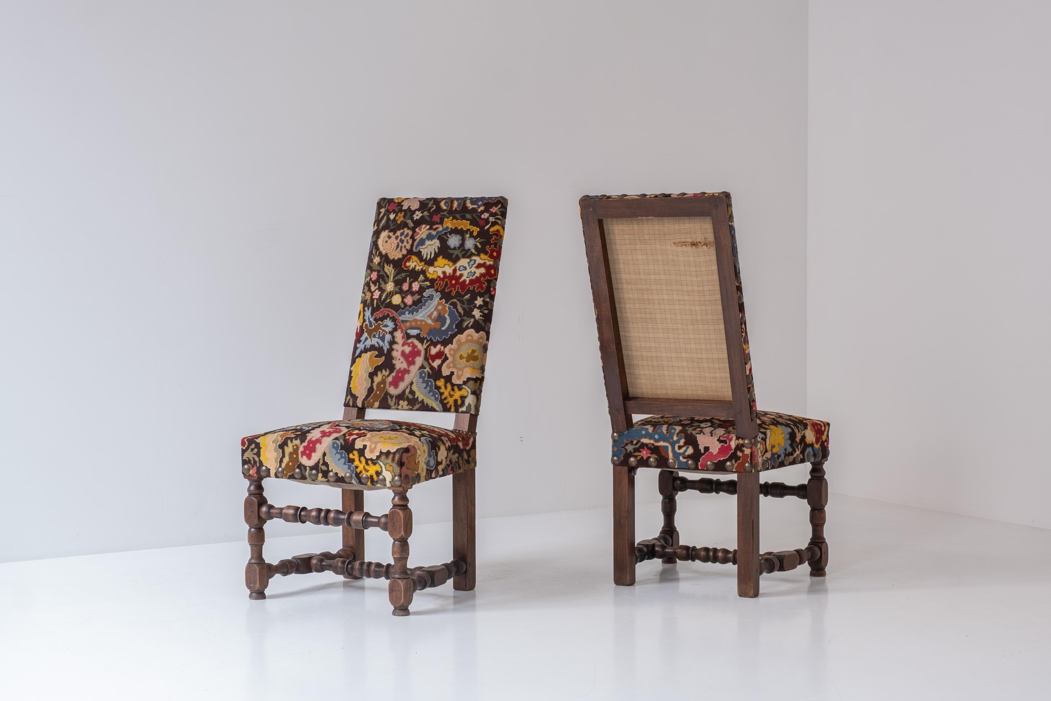Rare pair baroque side chairs from France, circa 1890. These late 19th century chairs are made out of walnut and upholstered with old colorful tapestry. Elegant twisted frame with nice brass details. Very comfortable and stable seating. Visible