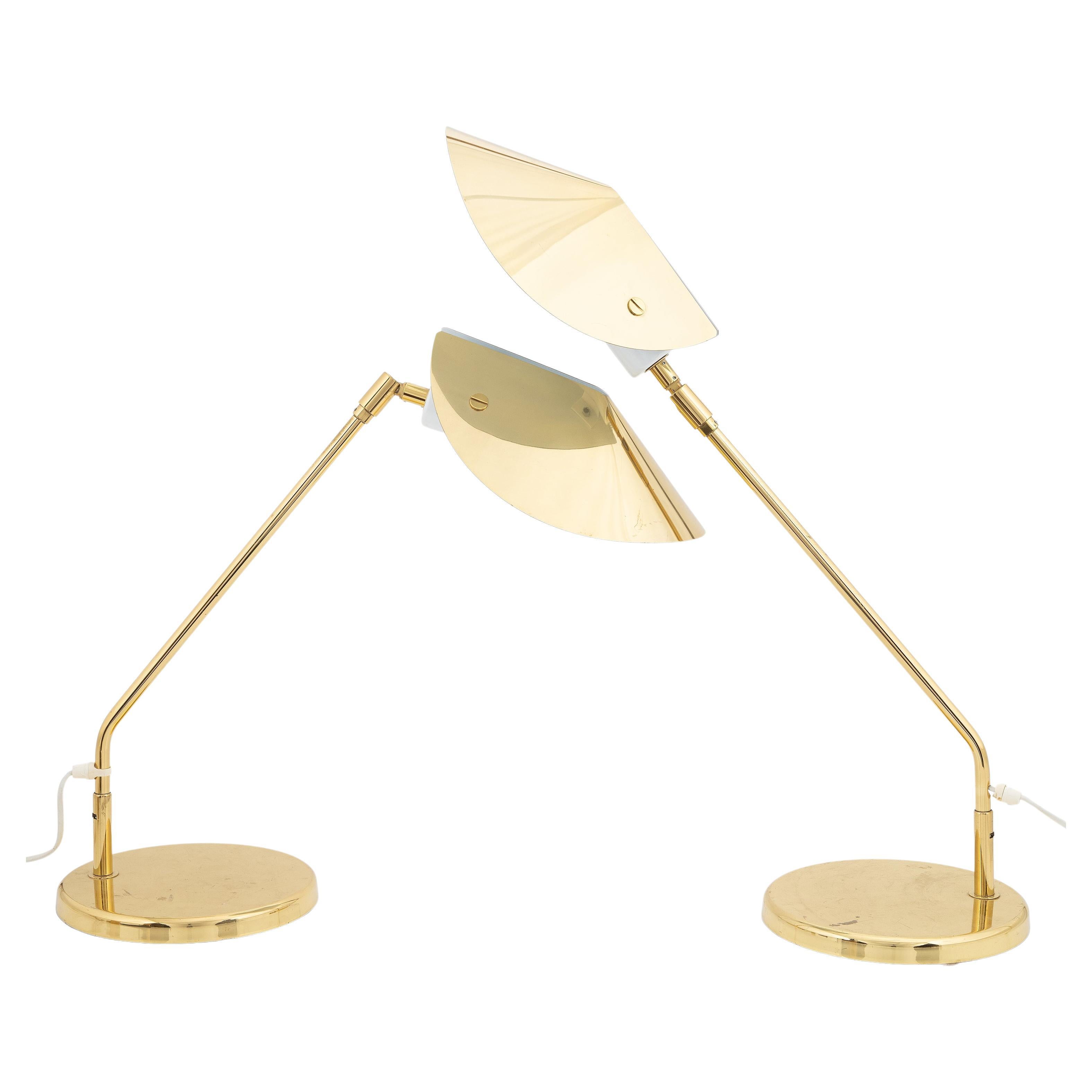 Rare brass table lamp/ desk lamp  from the Swedish brand Aneta. The brass cap is bent around a white metal perforated plate like a monkshood. The curved arm rotates on the heavy foot and the hood can turn and bend up and down.
White performed metal
