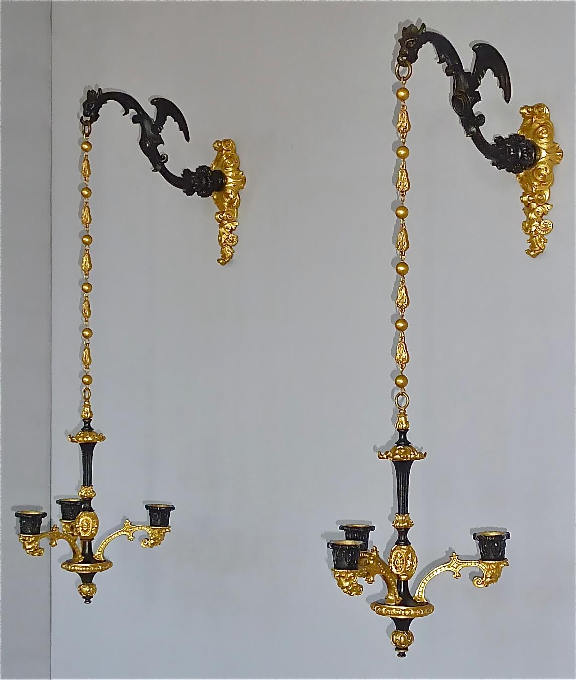 Incredible large french and rare pair of Charles X / Biedermeier winged dragons wall lights or candle holder, France early 19th Century around 1830. The gorgeous antique dragon Gothic style appliques / sconces / wall lamps are made of cast blackened