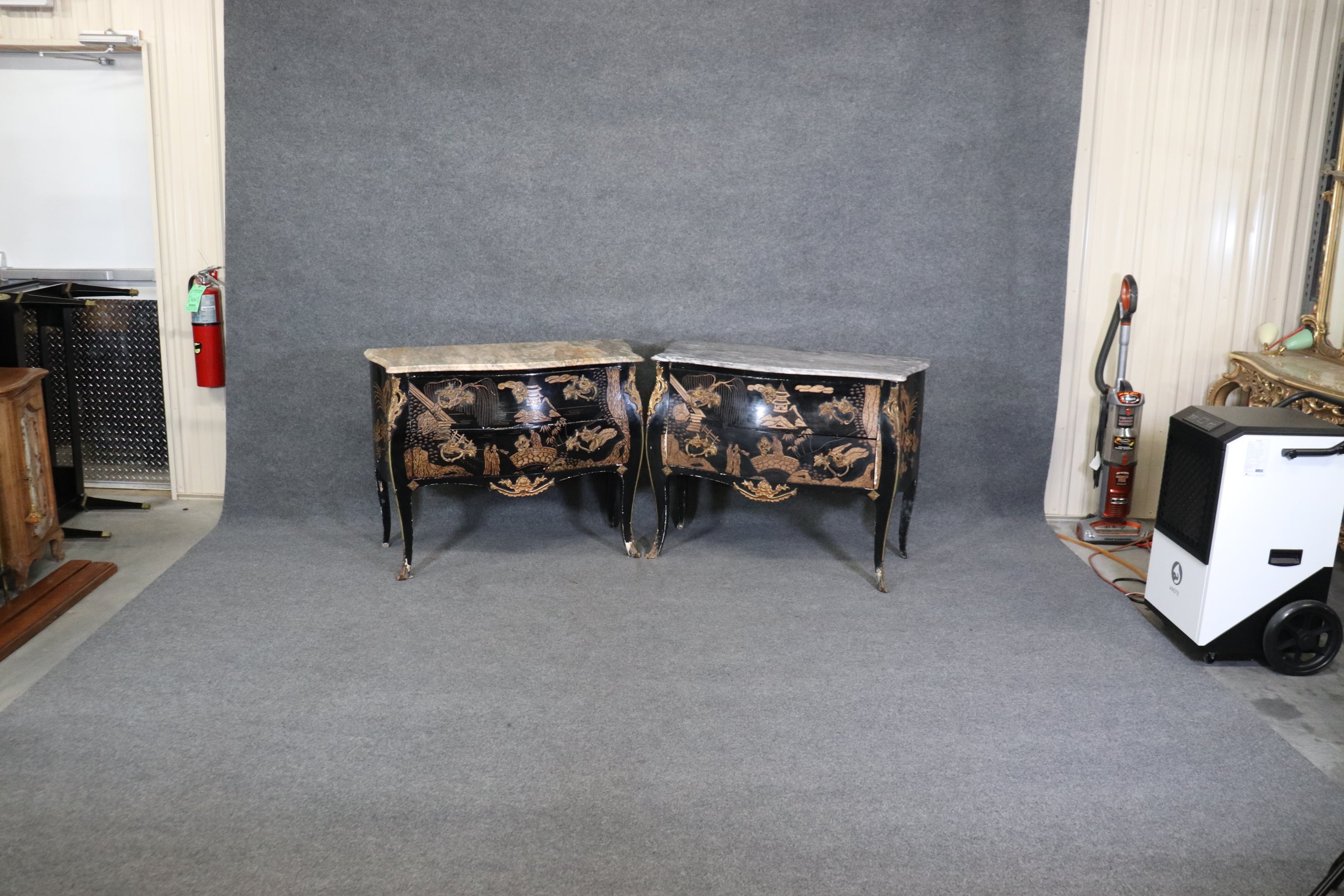 This is a rare pair of Coromandel carved lacquer commodes with their original time-worn finish and beautiful scenery. The cases match perfectly however the marble tops are of different species. Noth very noticable when spaced apart or in different