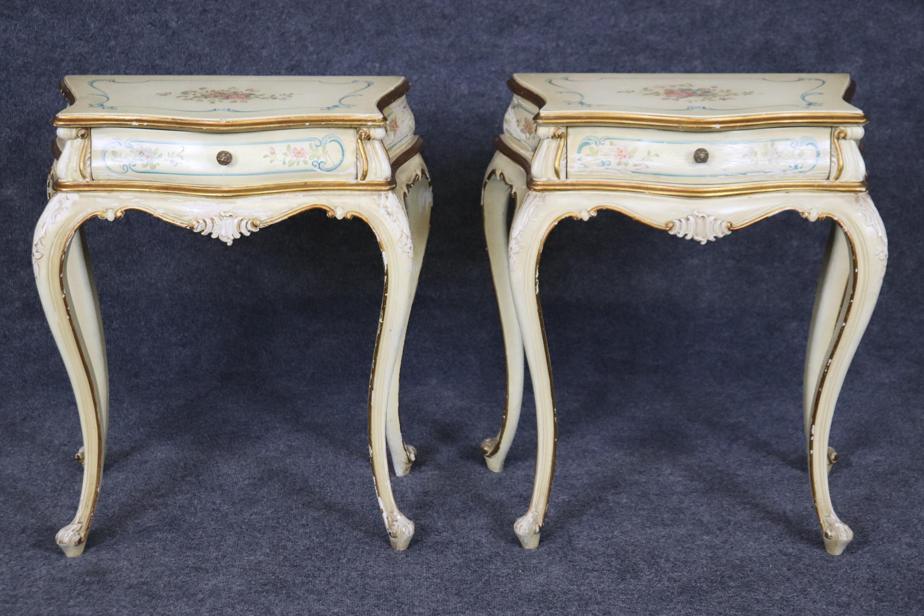 This is a great pair of Italian or Venetian paint decorated nightstands with distressed painted surfaces and gorgeous design elements and gold leaf details. Measures 25.5 tall x 22.75 wide x 12.5 and has considerable paint distressing and losses.