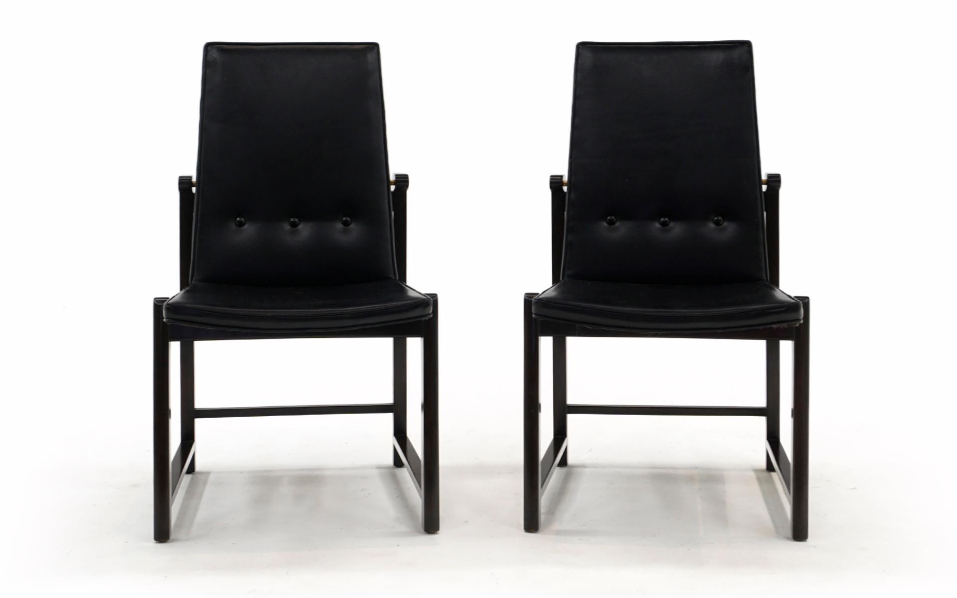 Très rares et désirables chaises de salle à manger Dunbar à haut dossier conçues par Edward Wormley. Les deux chaises sont complètement originales. Le cuir noir d'origine n'a pas de déchirures, d'éraflures ou de réparations et présente un léger