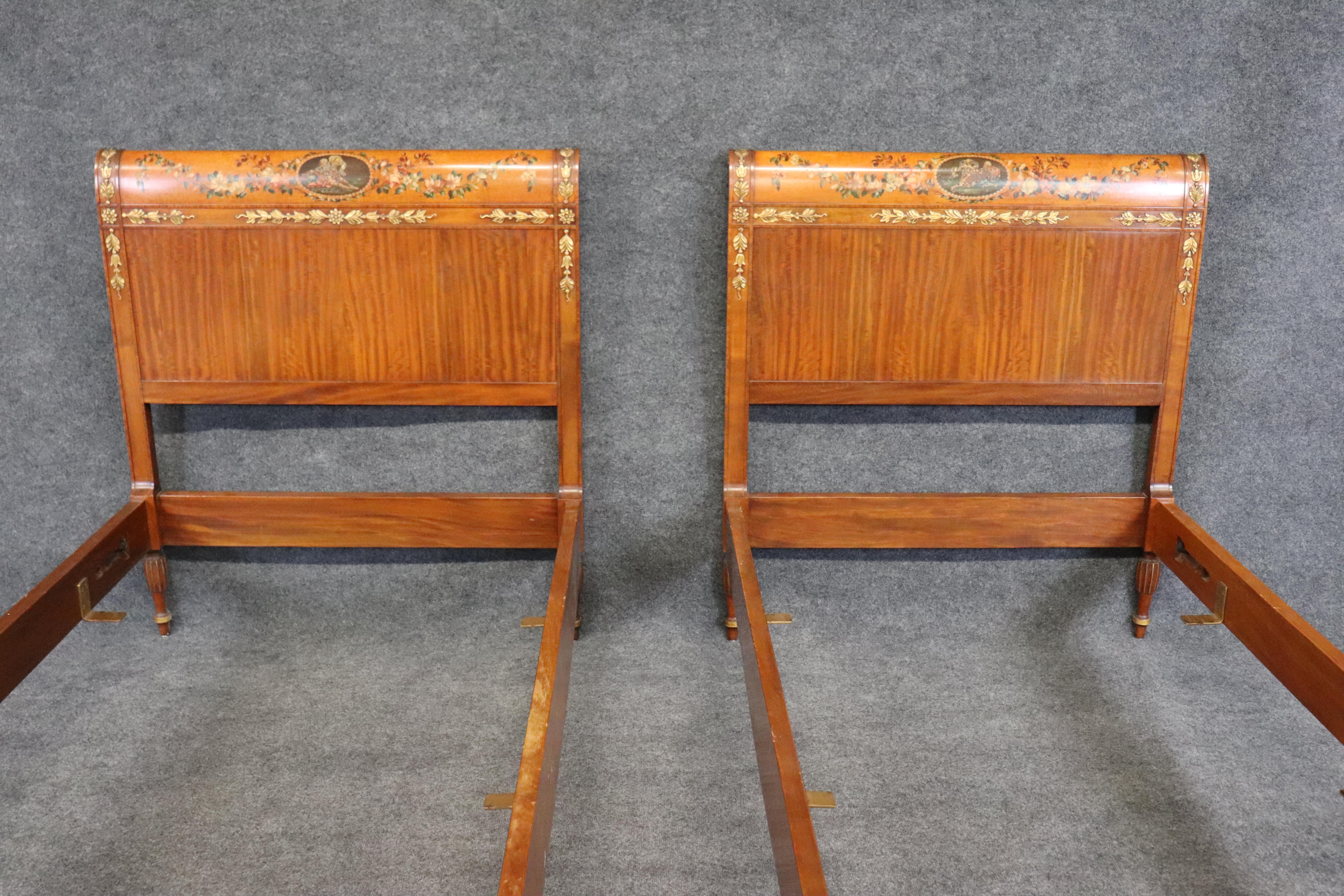 This is a fantastic antique pair of Adams style twin size beds. The beds are English and will be slightly different and smaller in terms of a US standard size twin size and mattress. The beds show some minor losses of paint and a missing carved